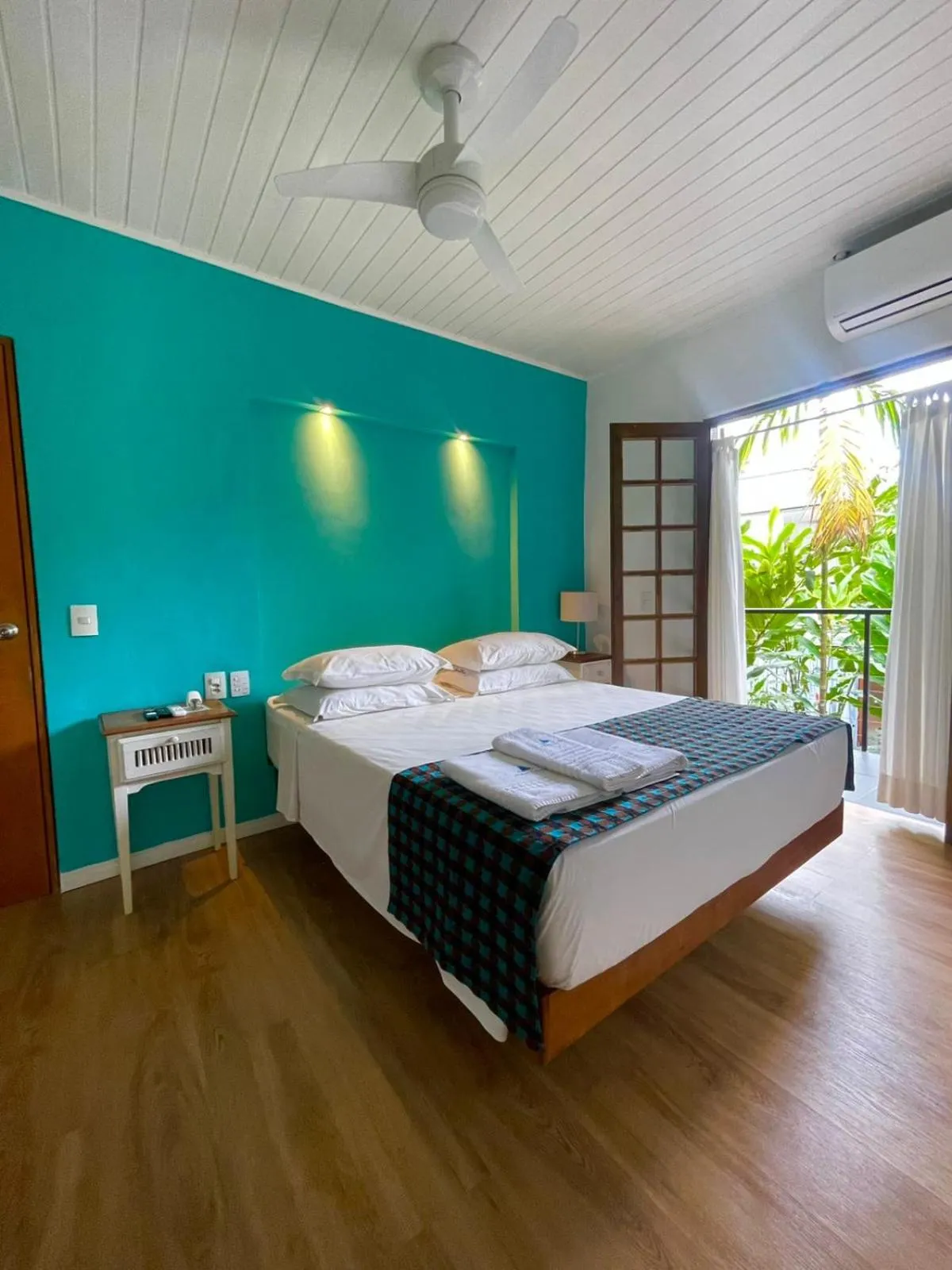 Bed in Pousada Armação de Camburi