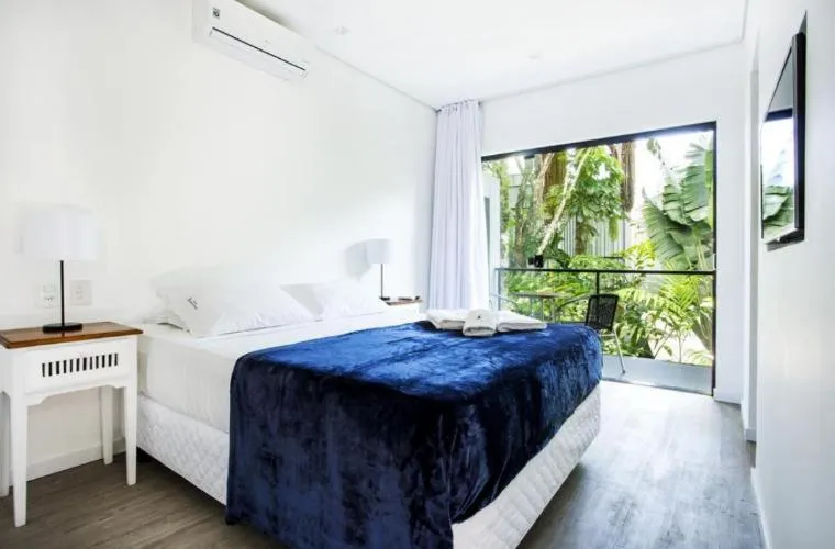 Bed in Pousada Armação de Camburi