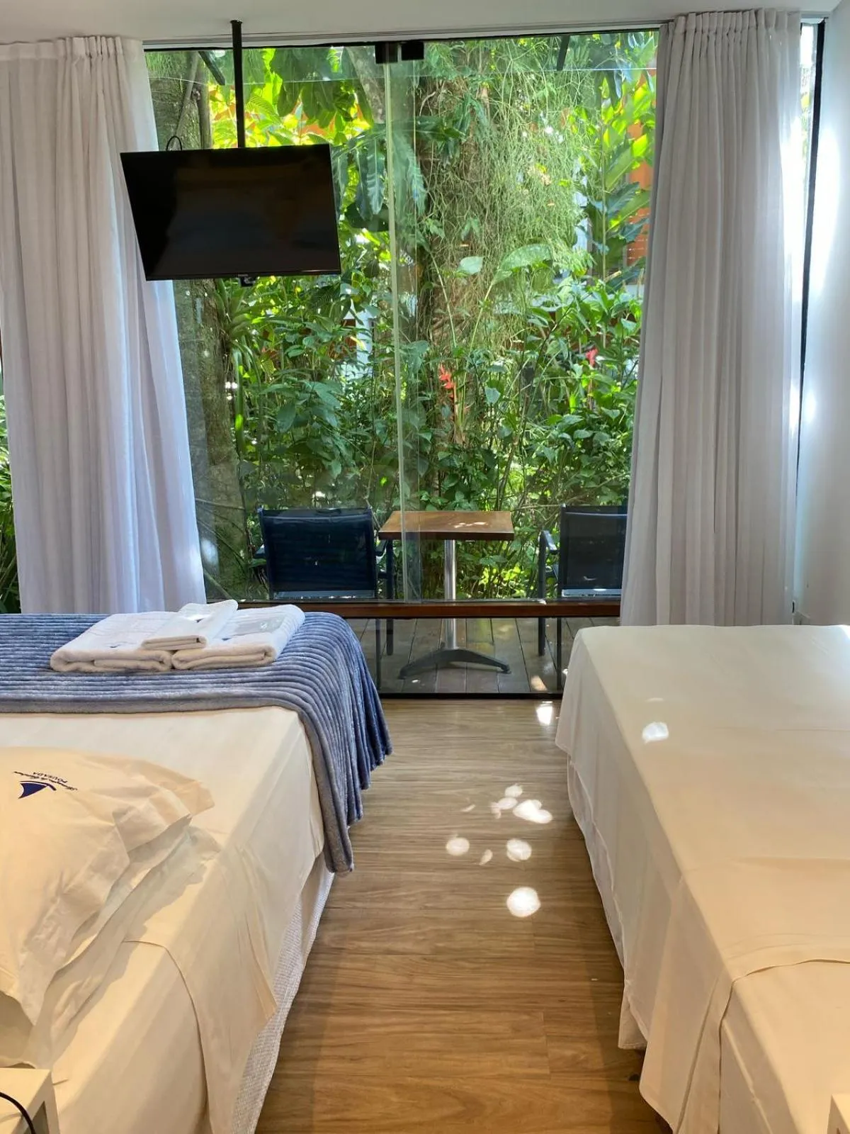 Bed in Pousada Armação de Camburi