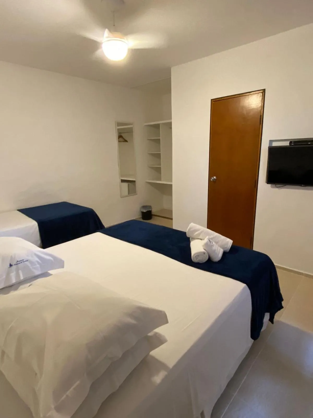Bed in Pousada Armação de Camburi