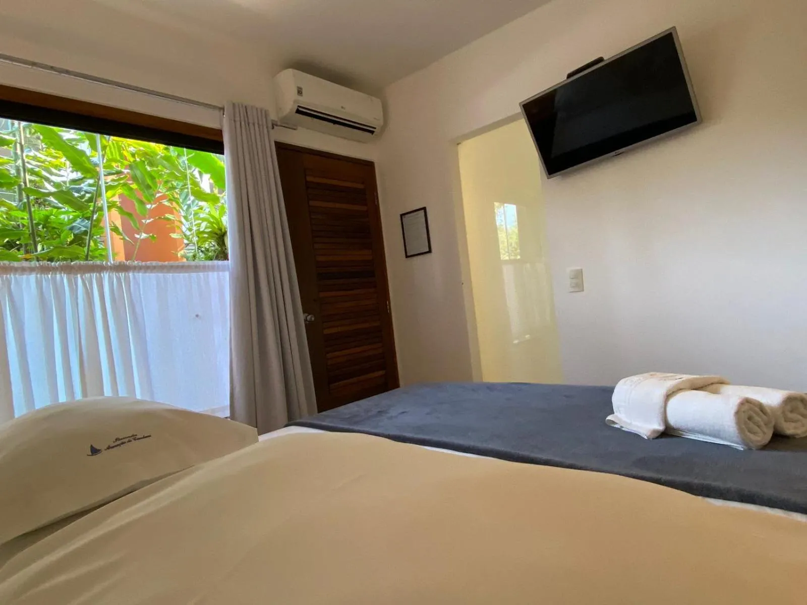 Bed in Pousada Armação de Camburi