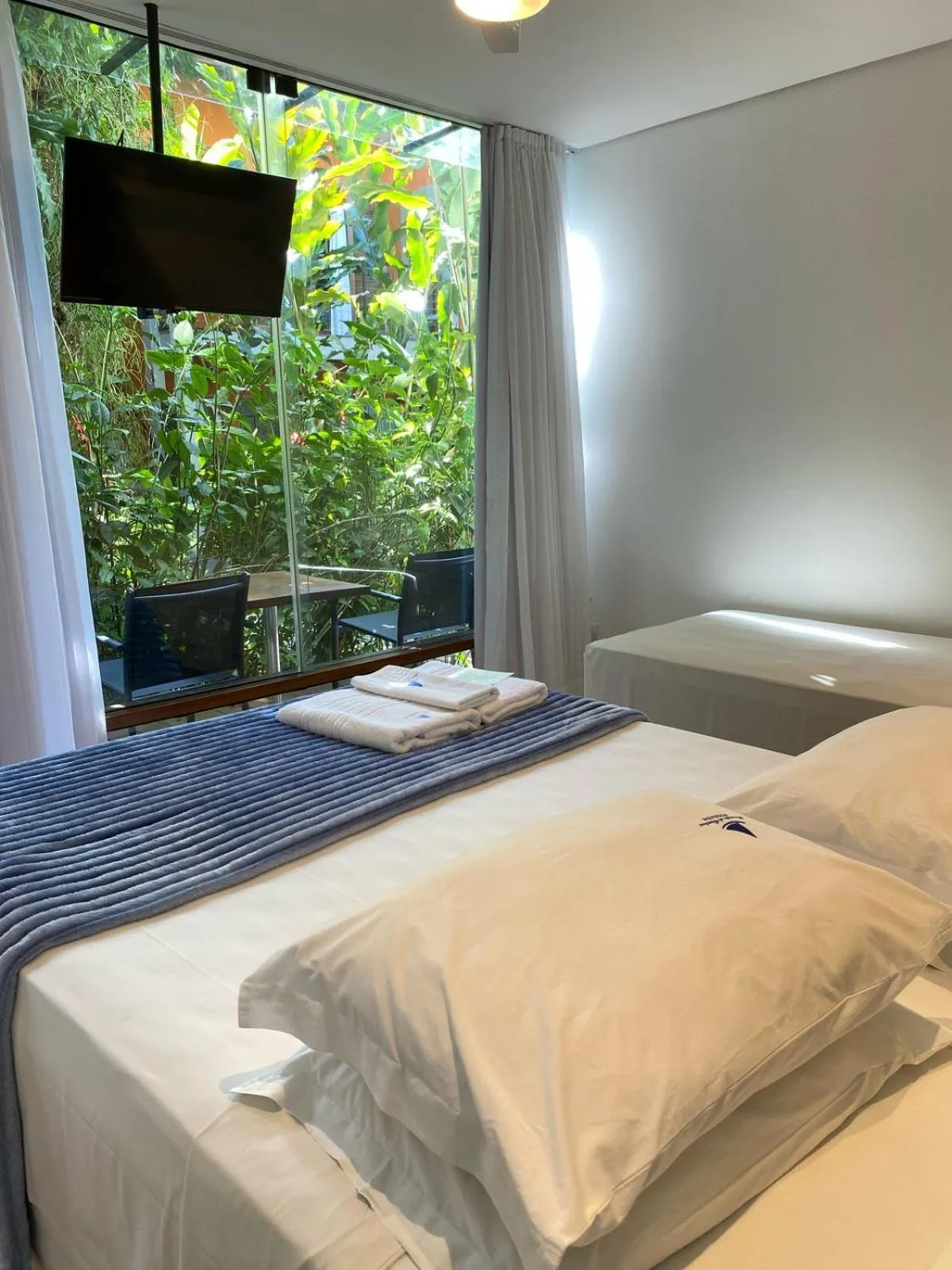 Bed in Pousada Armação de Camburi