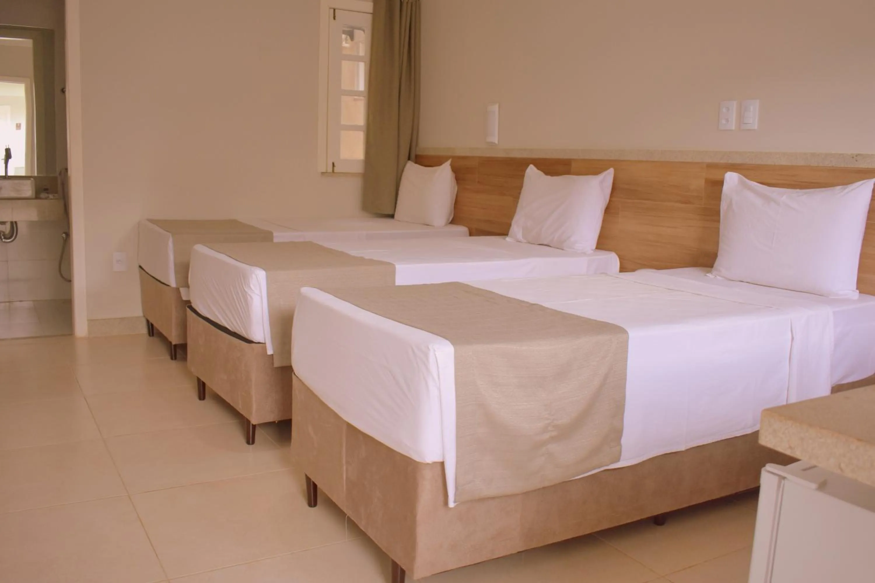 Bed in Tropical Mar Hotel