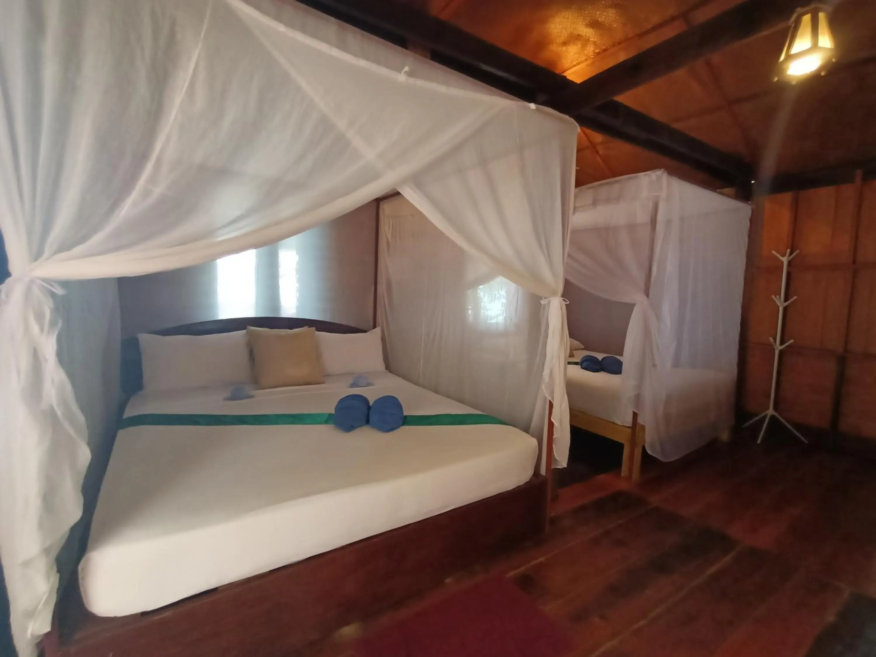 Bed in Jungle Hill Beach Bungalow
