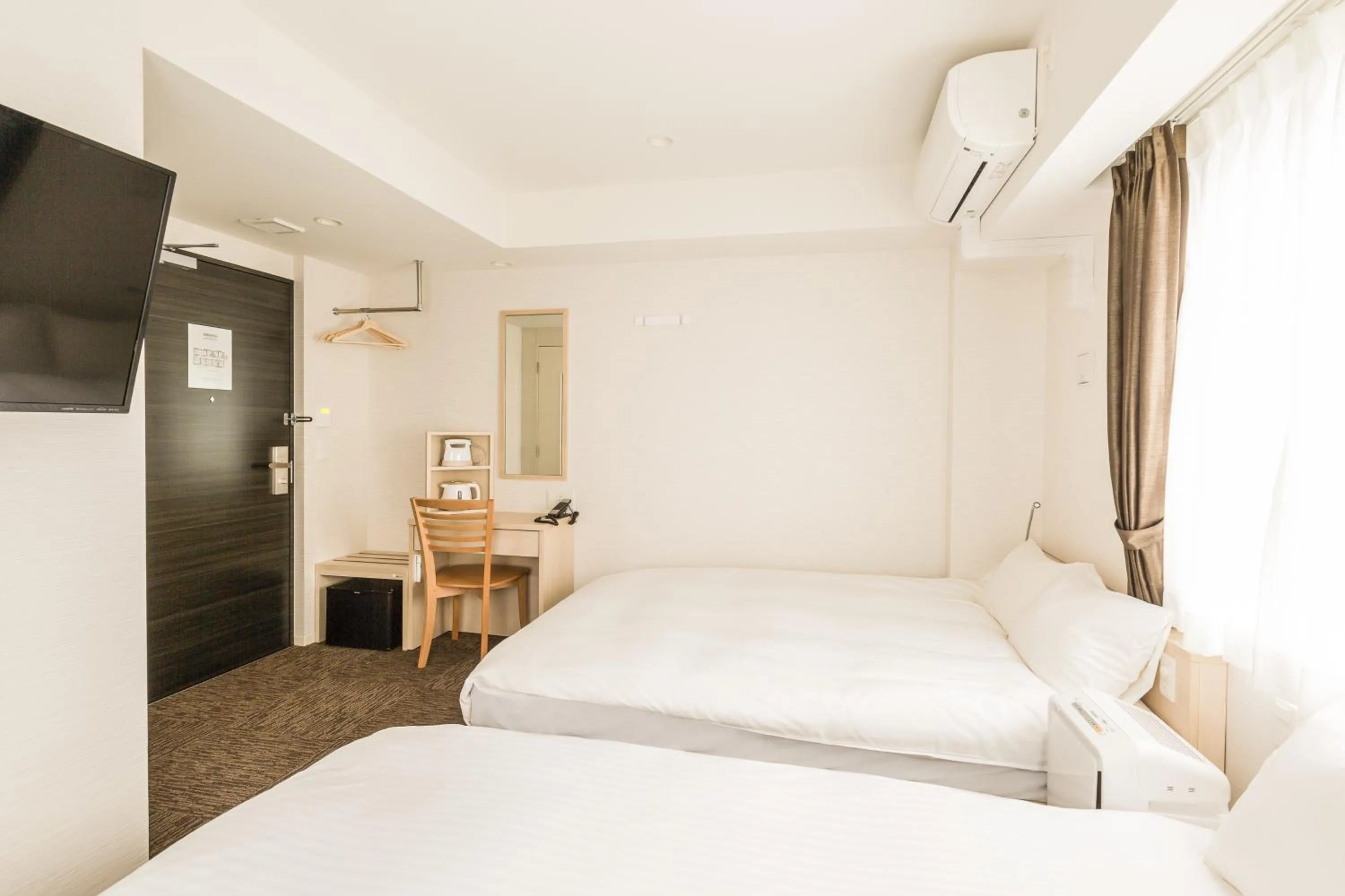 Photo of the whole room, Bed in EIWA PLACE HOTEL Hakata