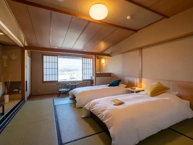 Bed in onsen hotel OMOTO