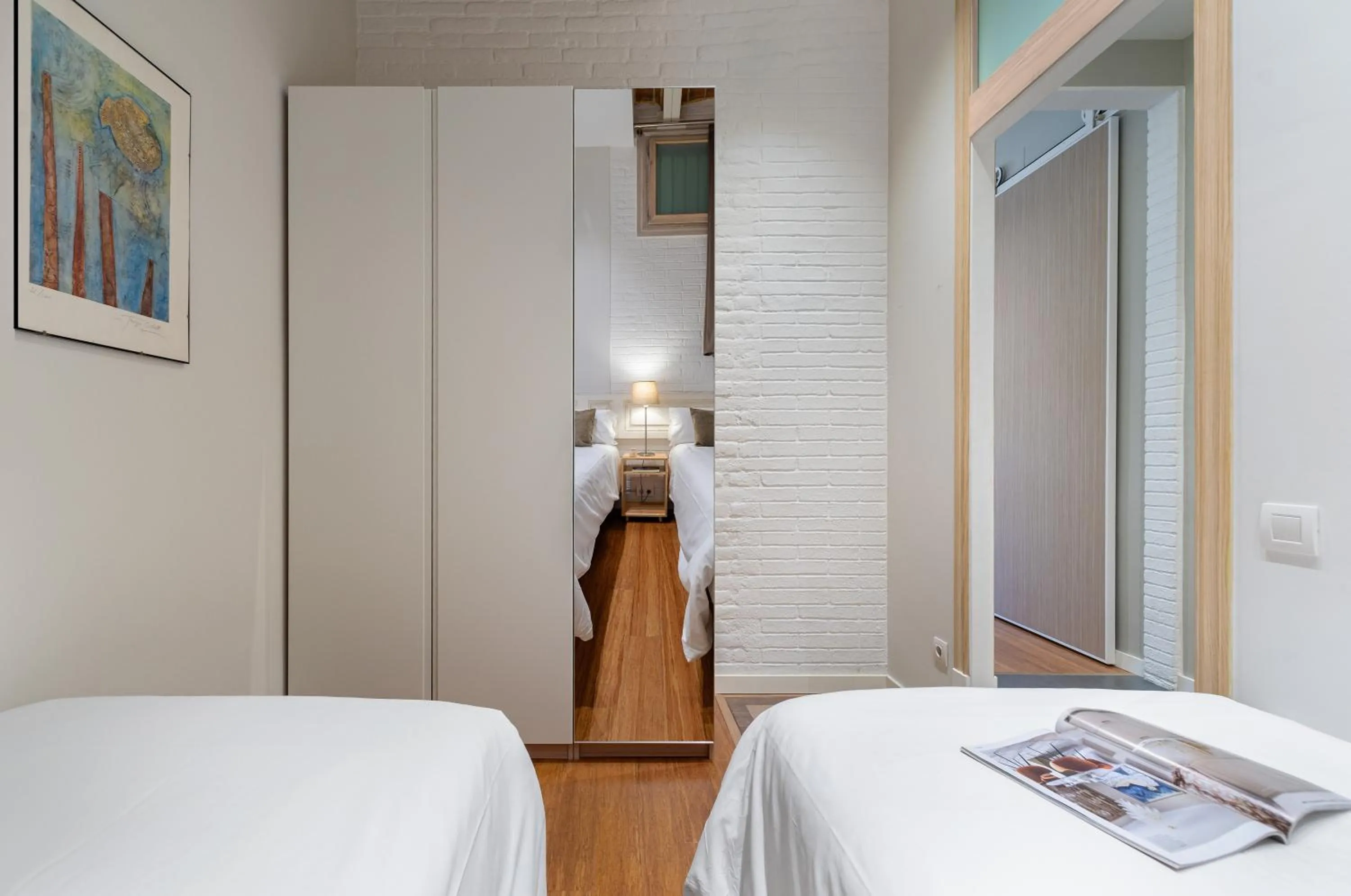 Bed in Fuster Apartments by Aspasios