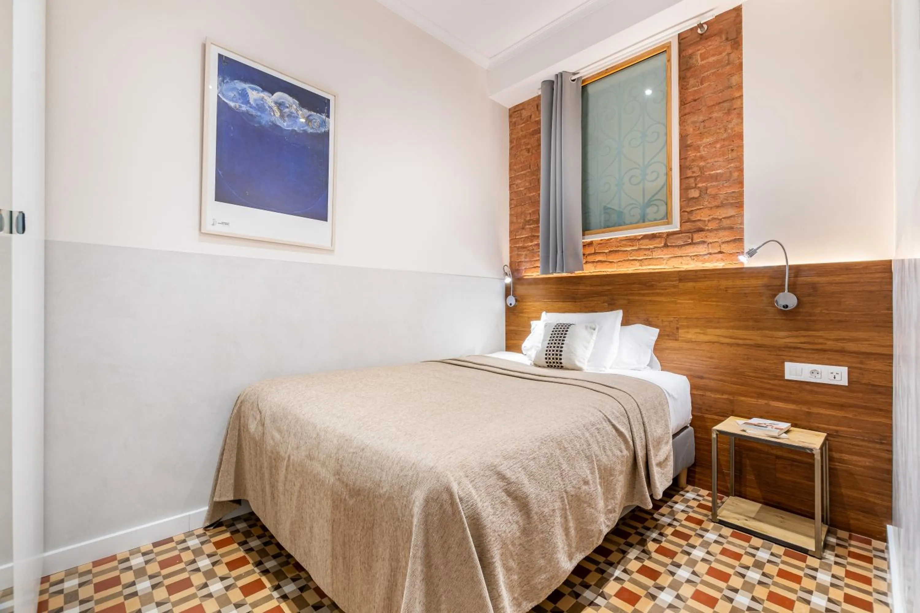 Bed in Fuster Apartments by Aspasios