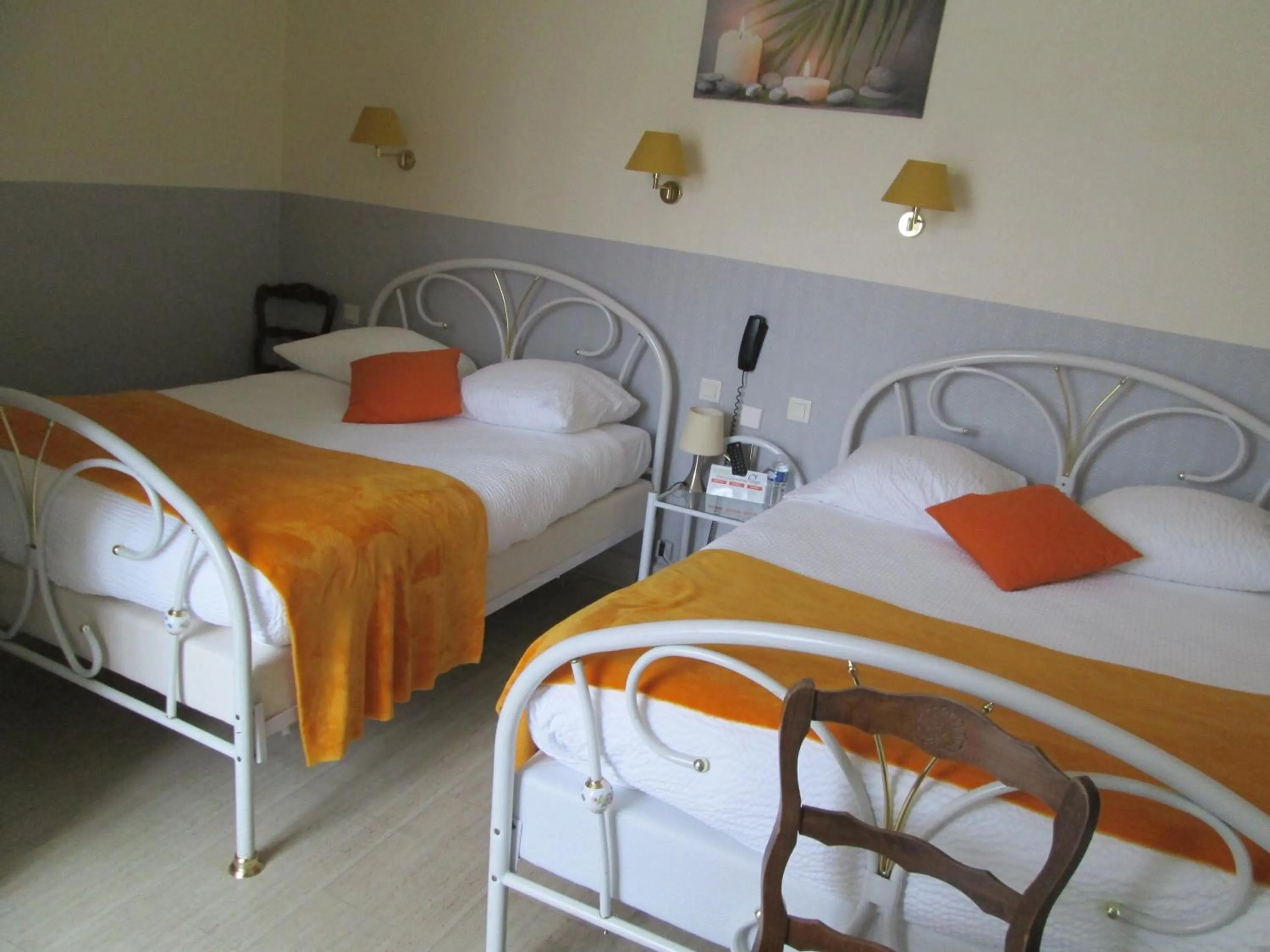 Bed in Logis Hôtel Beauséjour