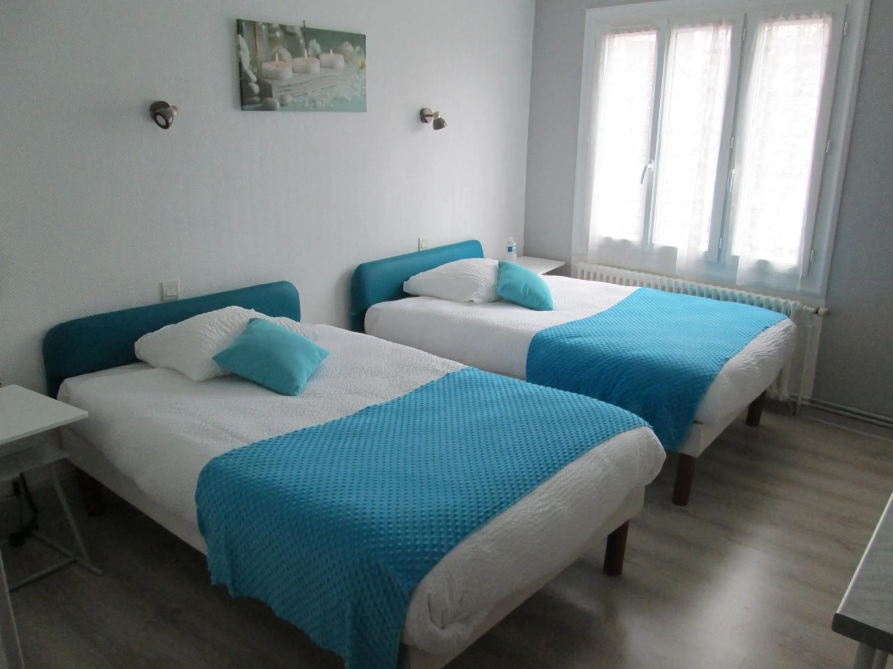 Bed in Logis Hôtel Beauséjour