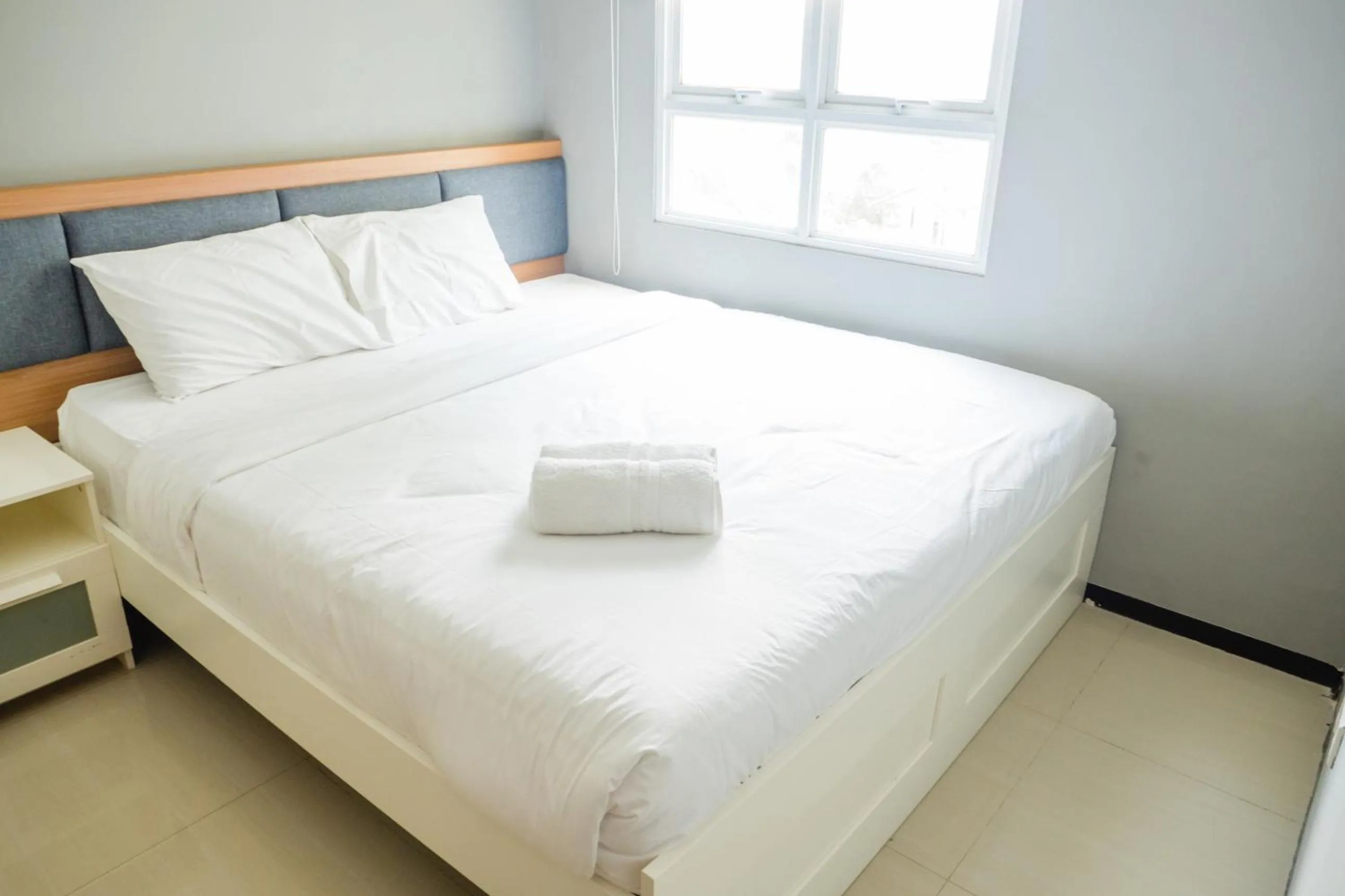 Bed in Pleasant 2BR Apartment at Gateway Pasteur By Travelio