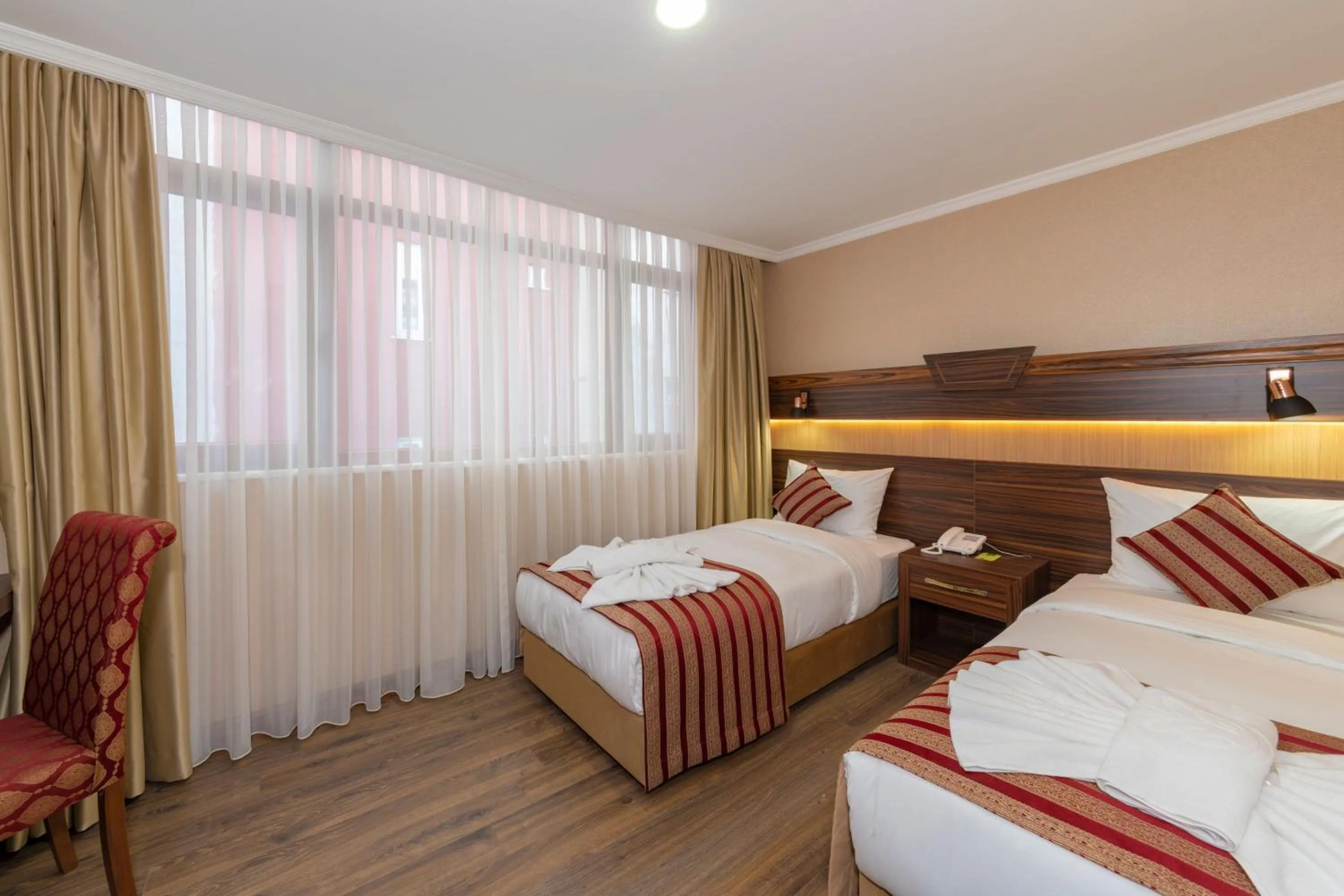 Bed in Vision Deluxe Hotel