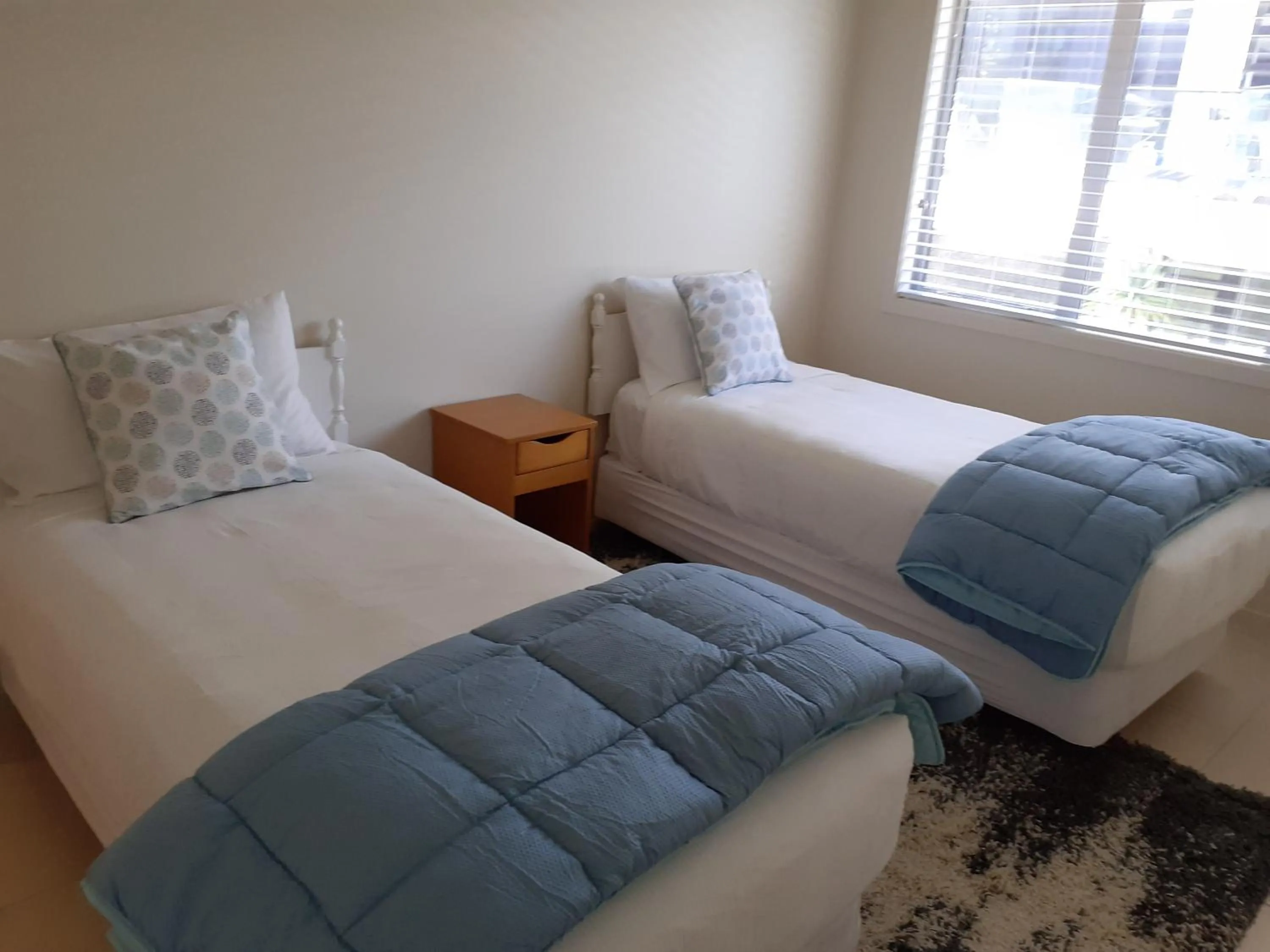 Bed in Pavilion Beachfront Apartments