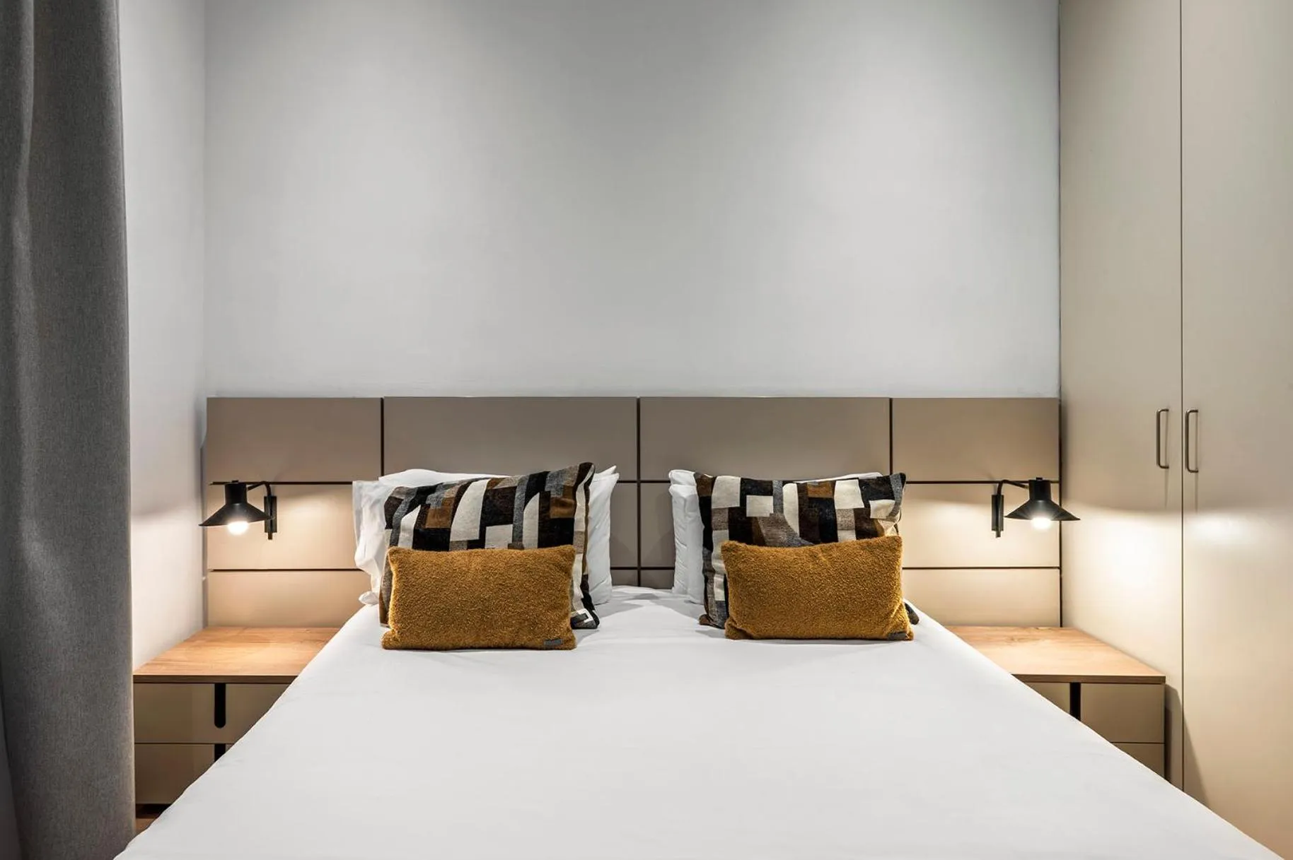 Bedroom, Bed in The Corner Apartments by Aspasios