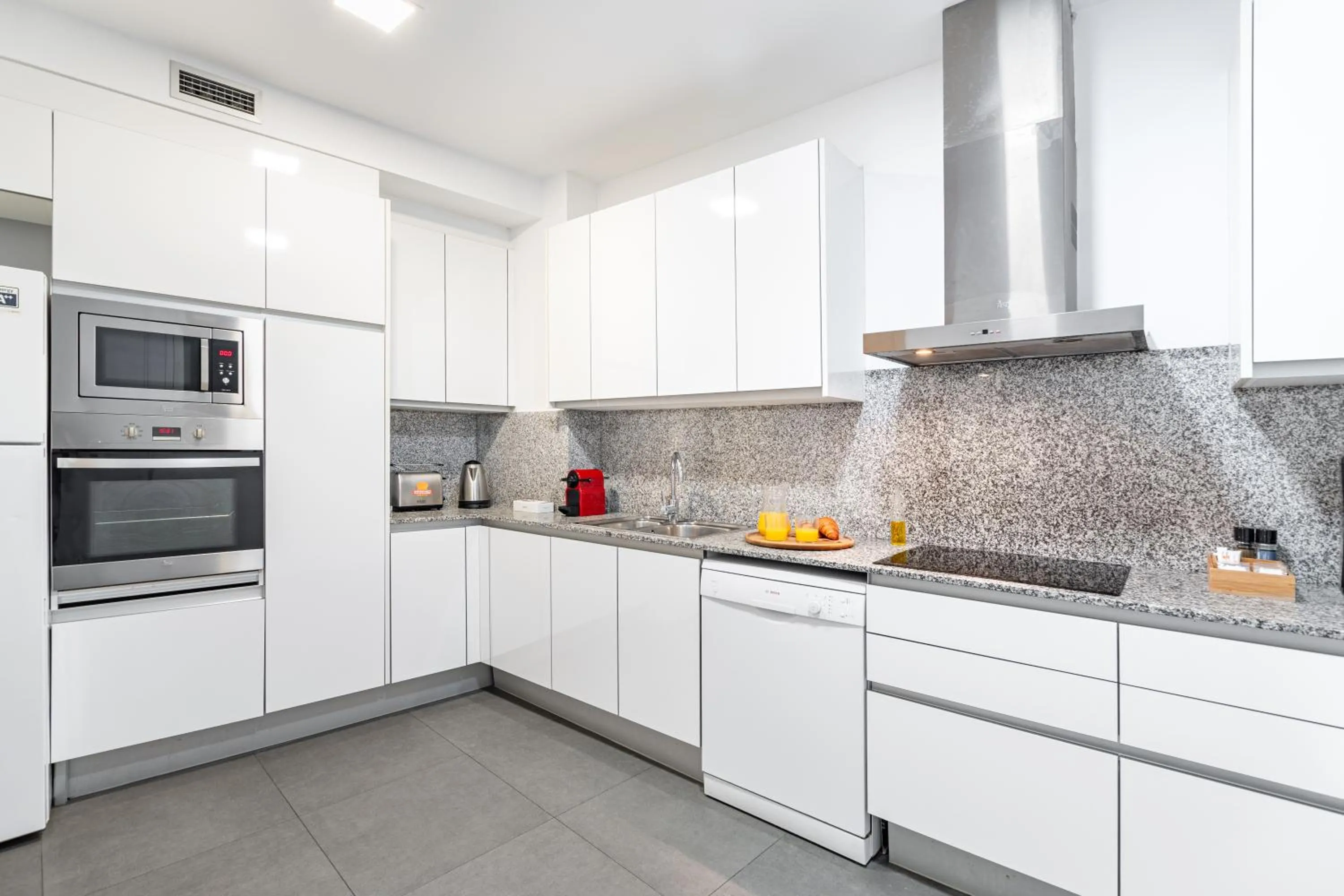 Kitchen or kitchenette in The Corner Apartments by Aspasios