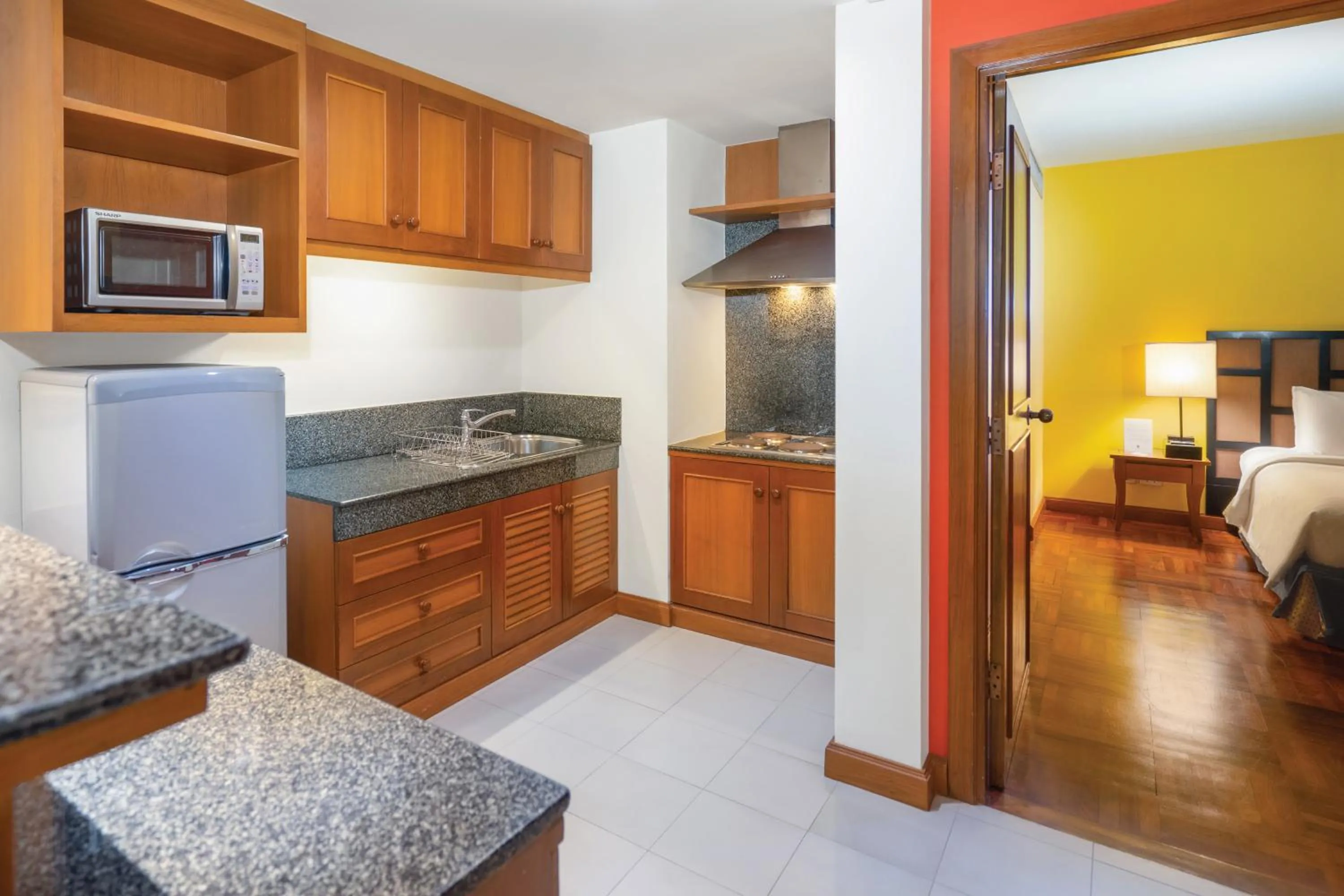 Kitchen or kitchenette, Bed in Homm Suites Laguna, part of Banyan Group