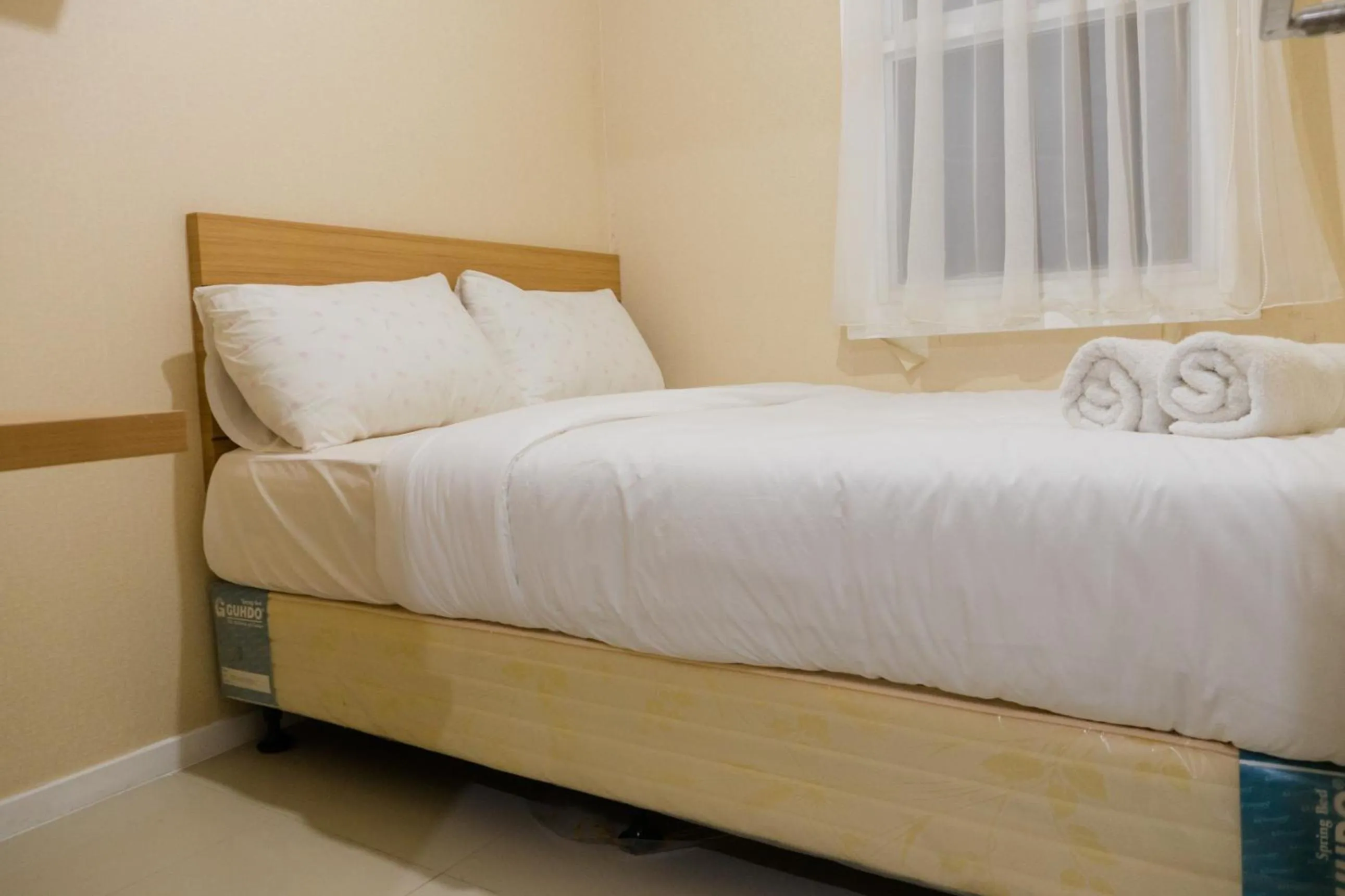 Bed in Minimalist 2BR Apartment at Parahyangan Residence By Travelio