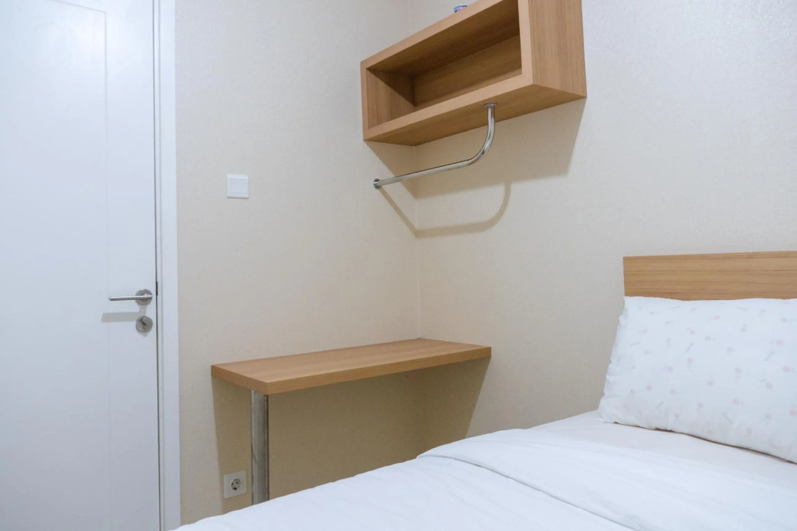 Bed in Minimalist 2BR Apartment at Parahyangan Residence By Travelio