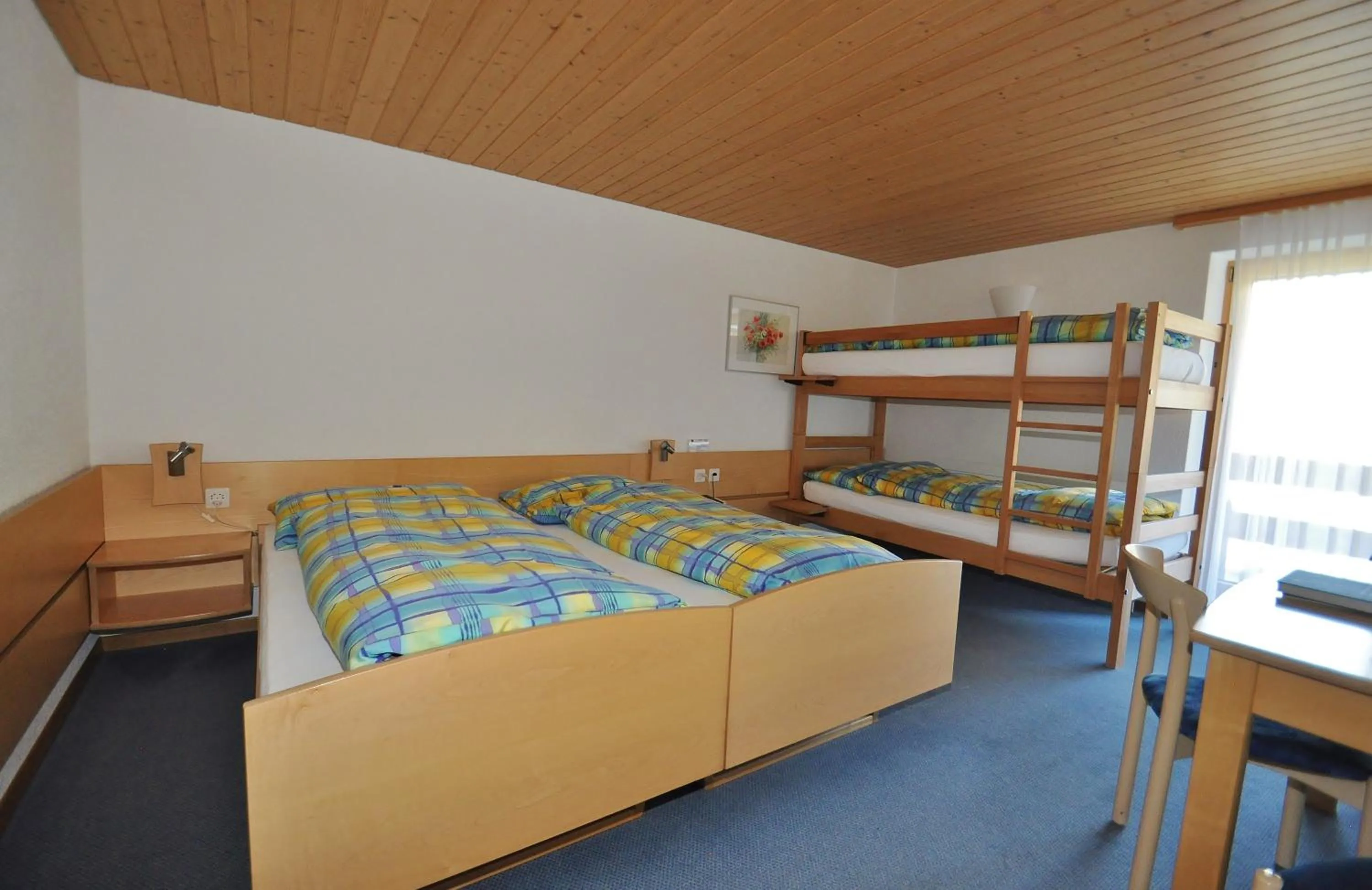 Photo of the whole room, Bed in Ferien- und Familienhotel Alpina Adelboden