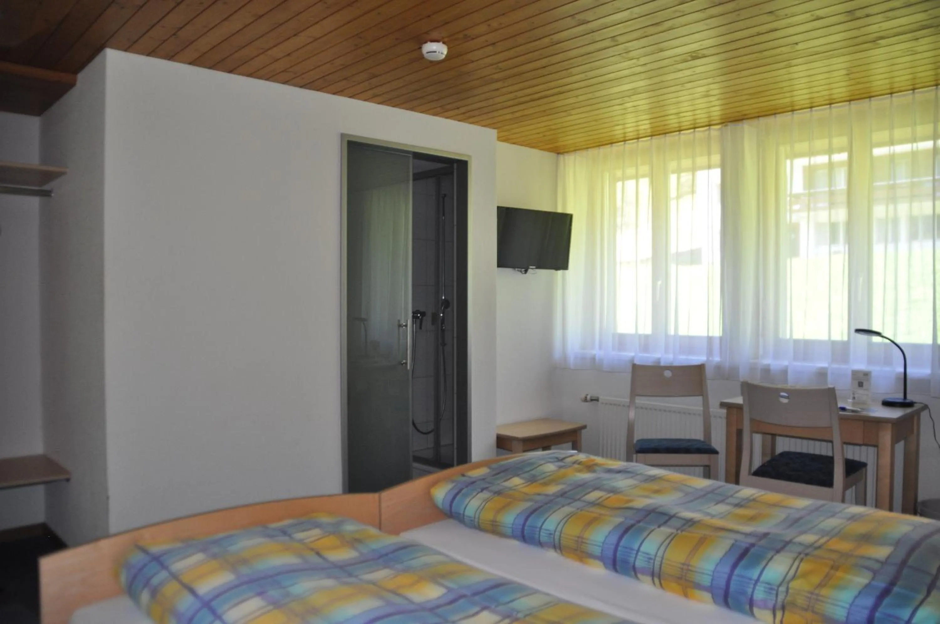 Photo of the whole room, Bed in Ferien- und Familienhotel Alpina Adelboden