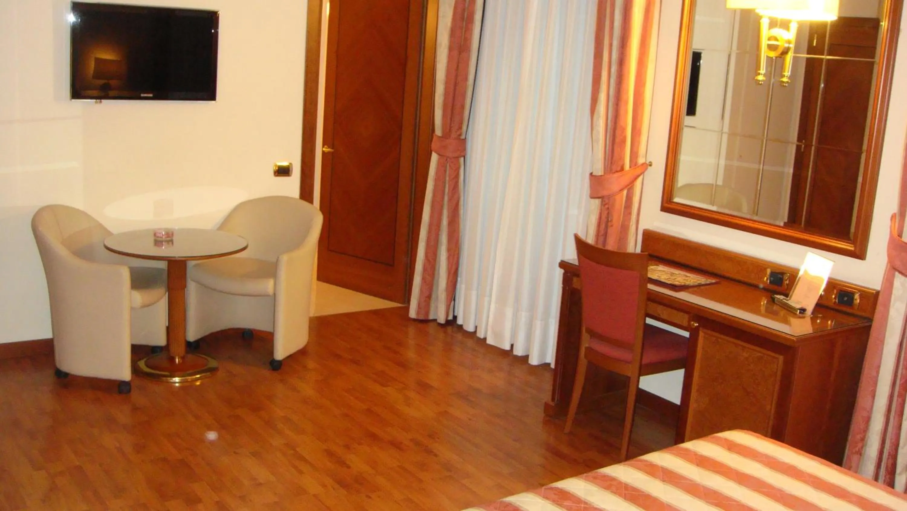 Seating area, Bed in Albergo Corona