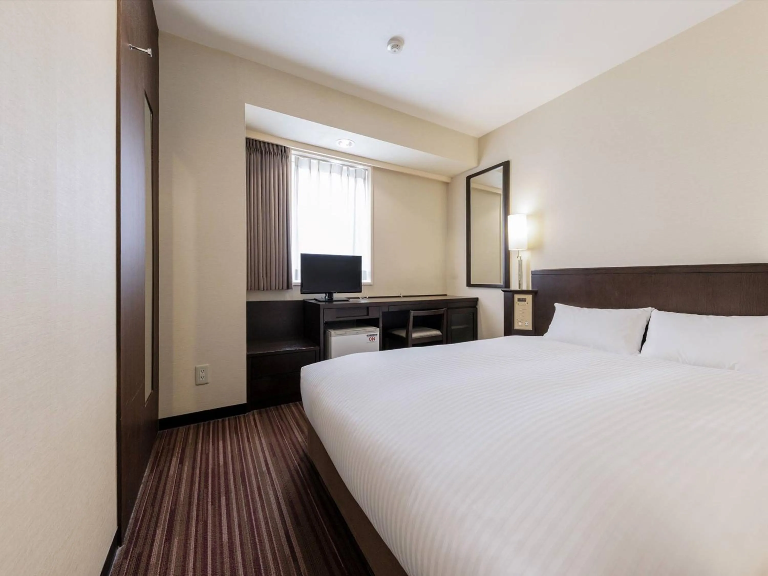 Bed in Nishitetsu Inn Kokura