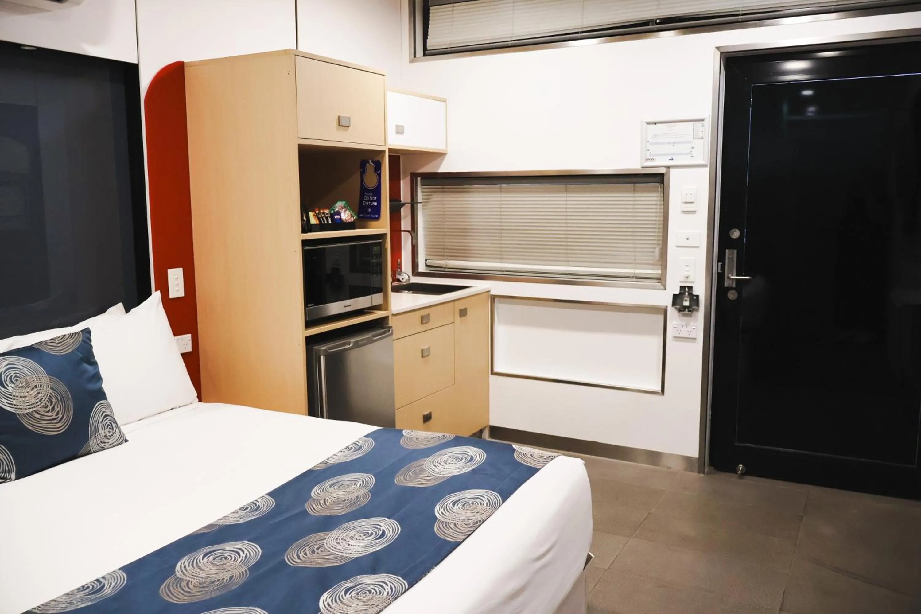 Kitchen or kitchenette, Bed in Stay Motel - Formerly Room Motels Gympie