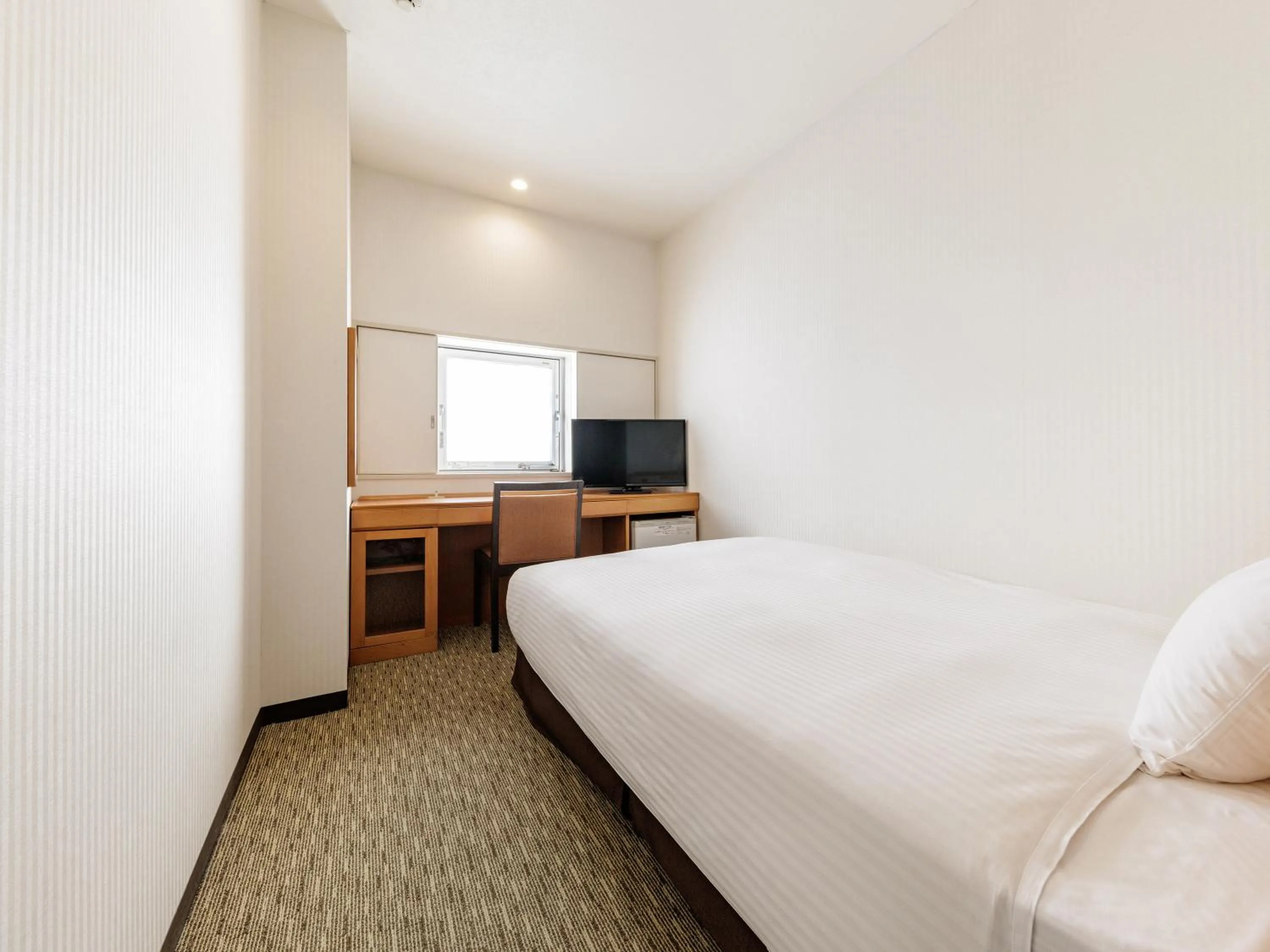 Bed in Nishitetsu Inn Kurosaki