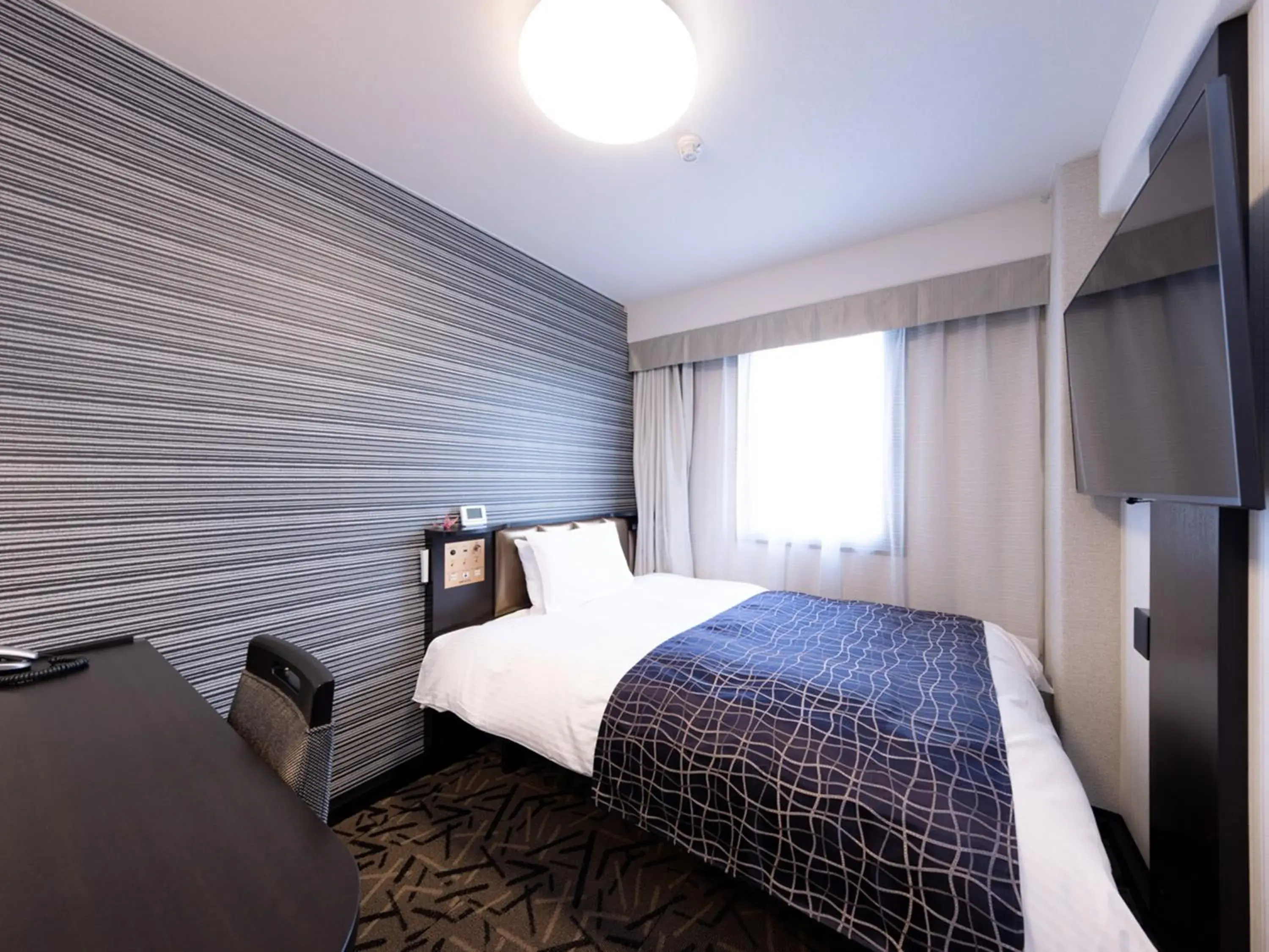 Bed in APA Hotel Miyazaki Eki Tachibanadori Bed in APA Hotel Miyazaki Eki Tachibanadori