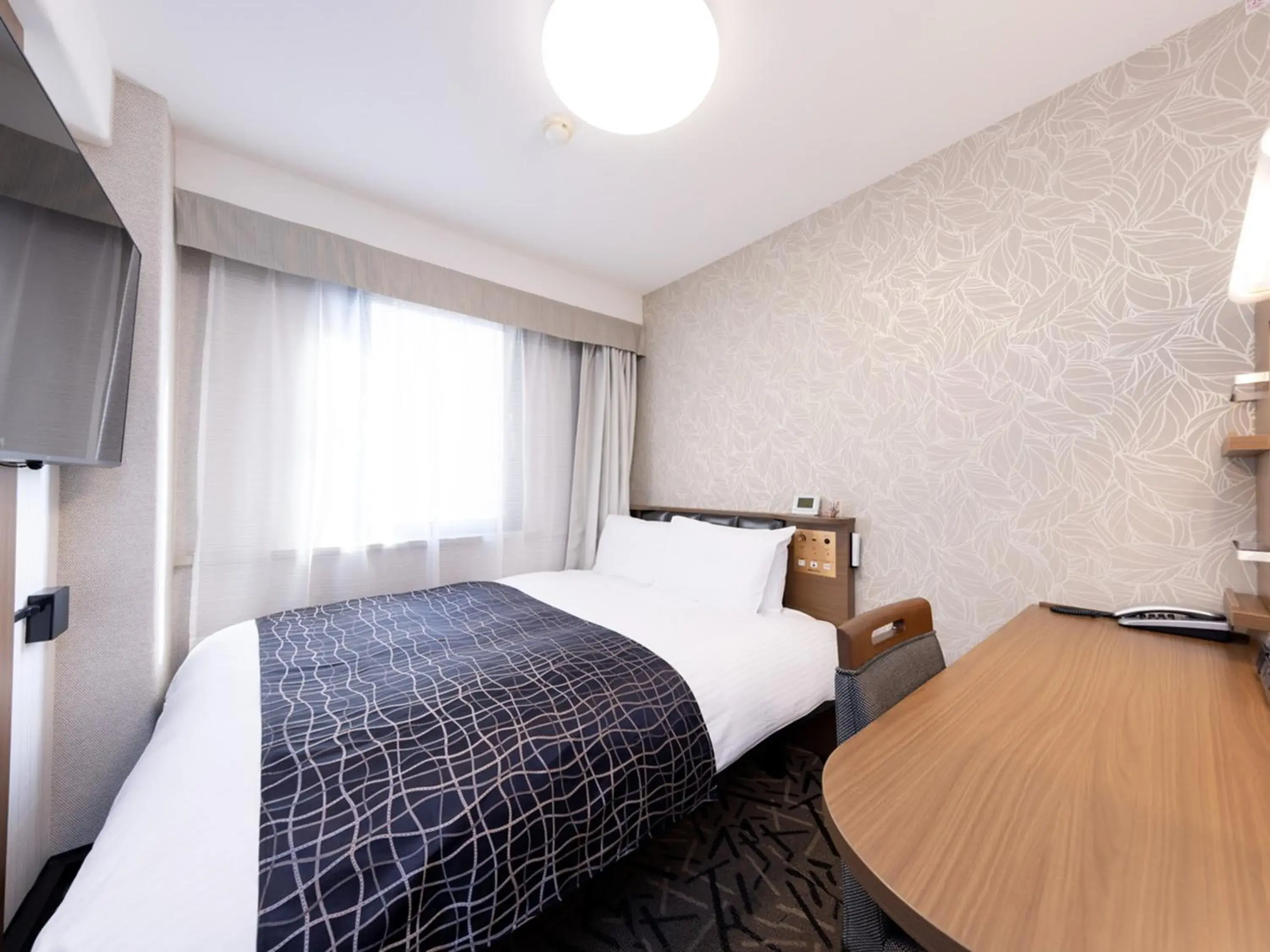 Bed in APA Hotel Miyazaki Eki Tachibanadori Bed in APA Hotel Miyazaki Eki Tachibanadori