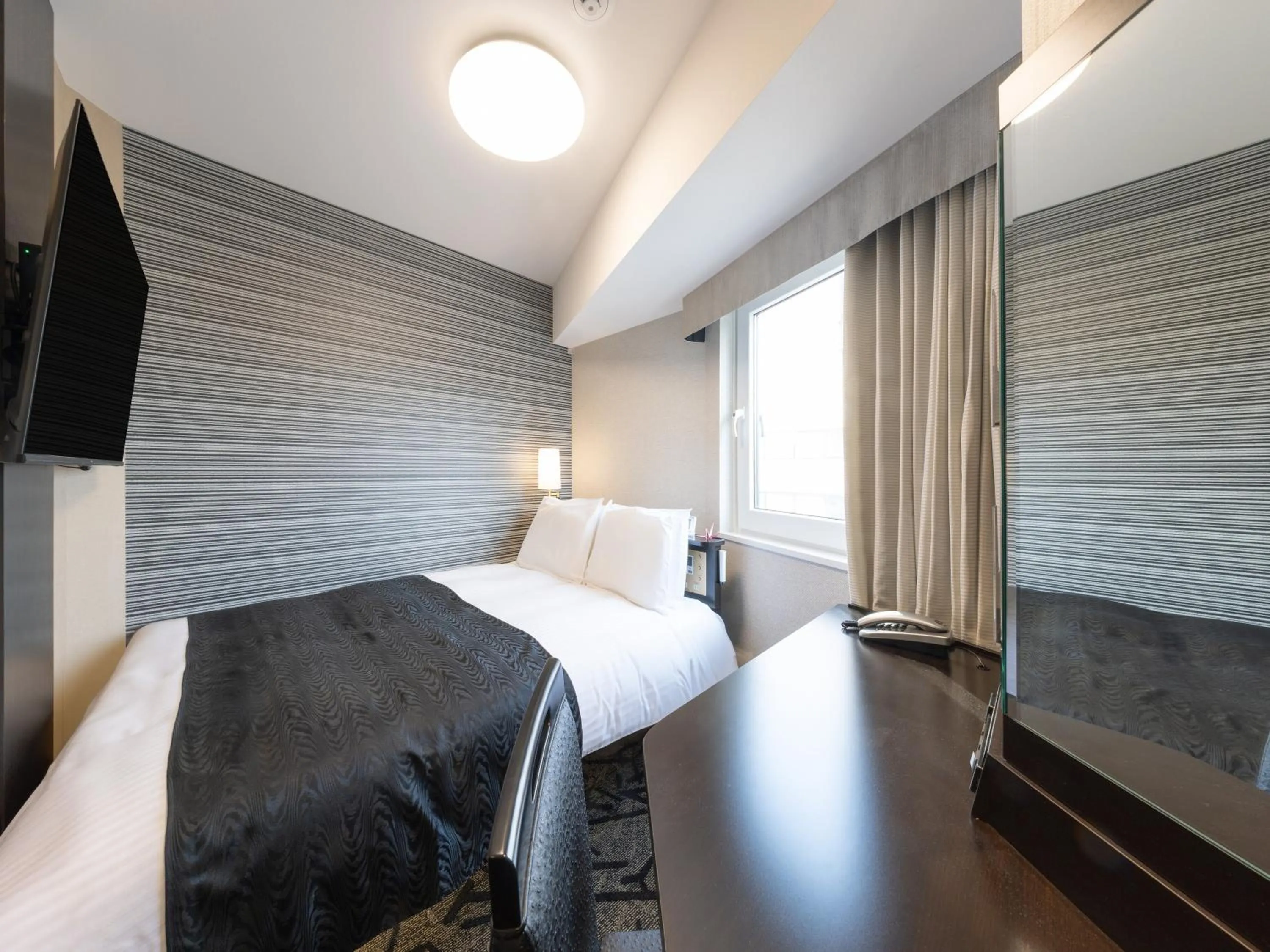 Photo of the whole room, Bed in APA Hotel Shibuya Dogenzakaue