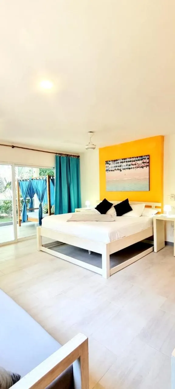 Bed in Blue Mango Beach Hotel