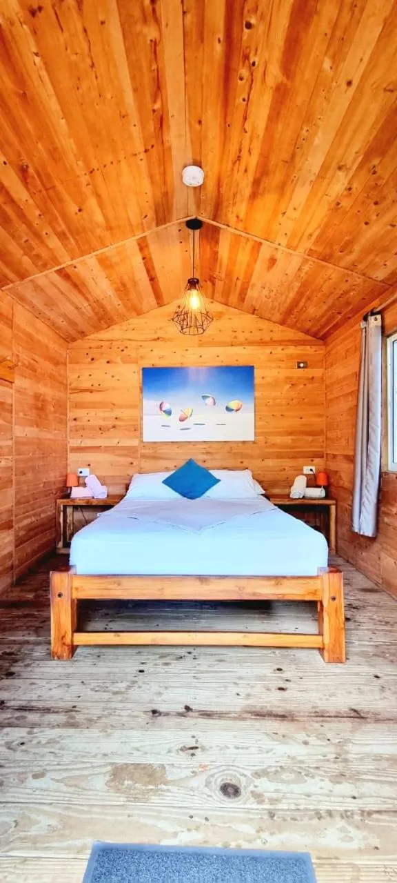 Bed in Blue Mango Beach Hotel