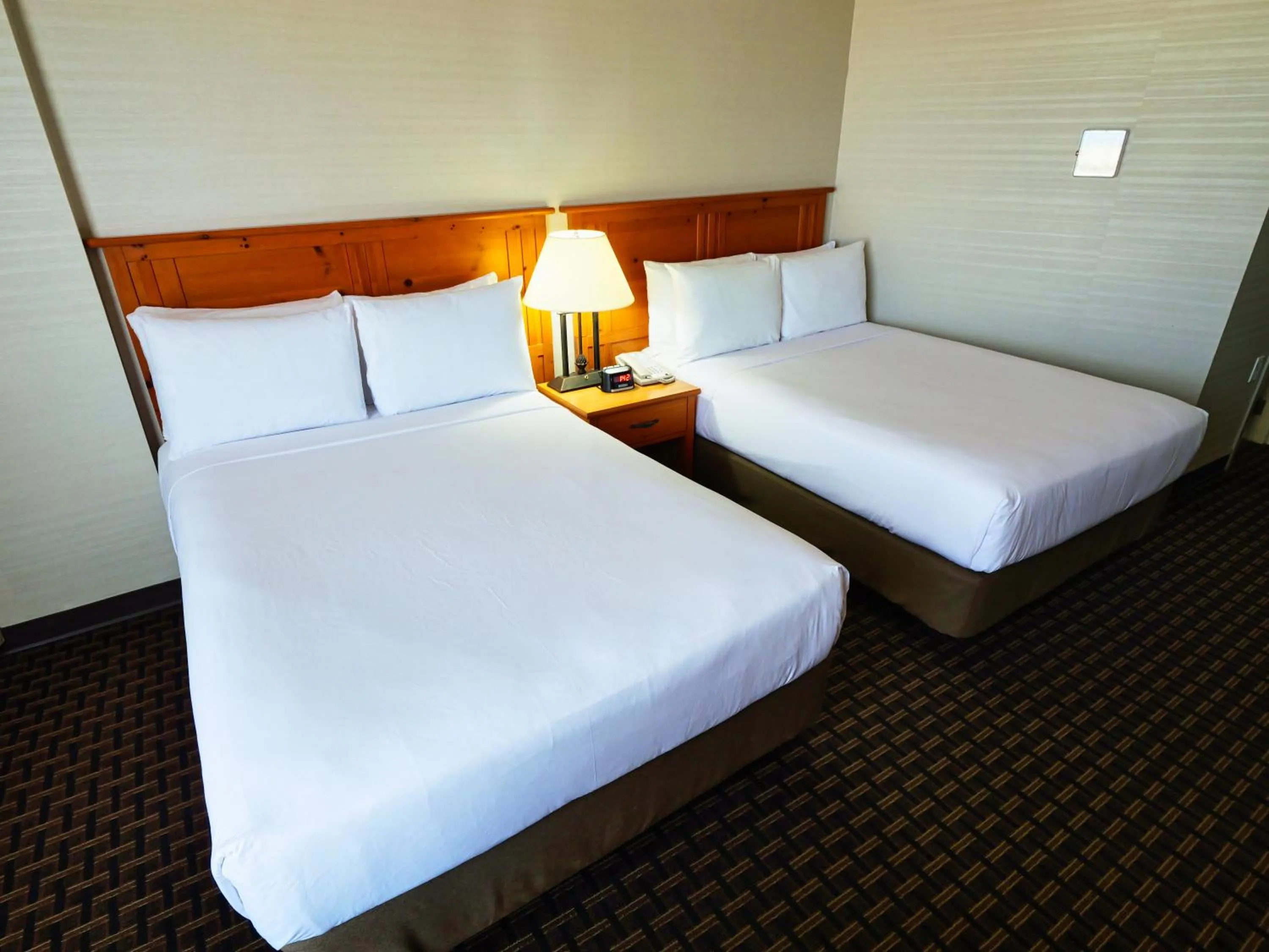 Bed in Continental Inn & Suites