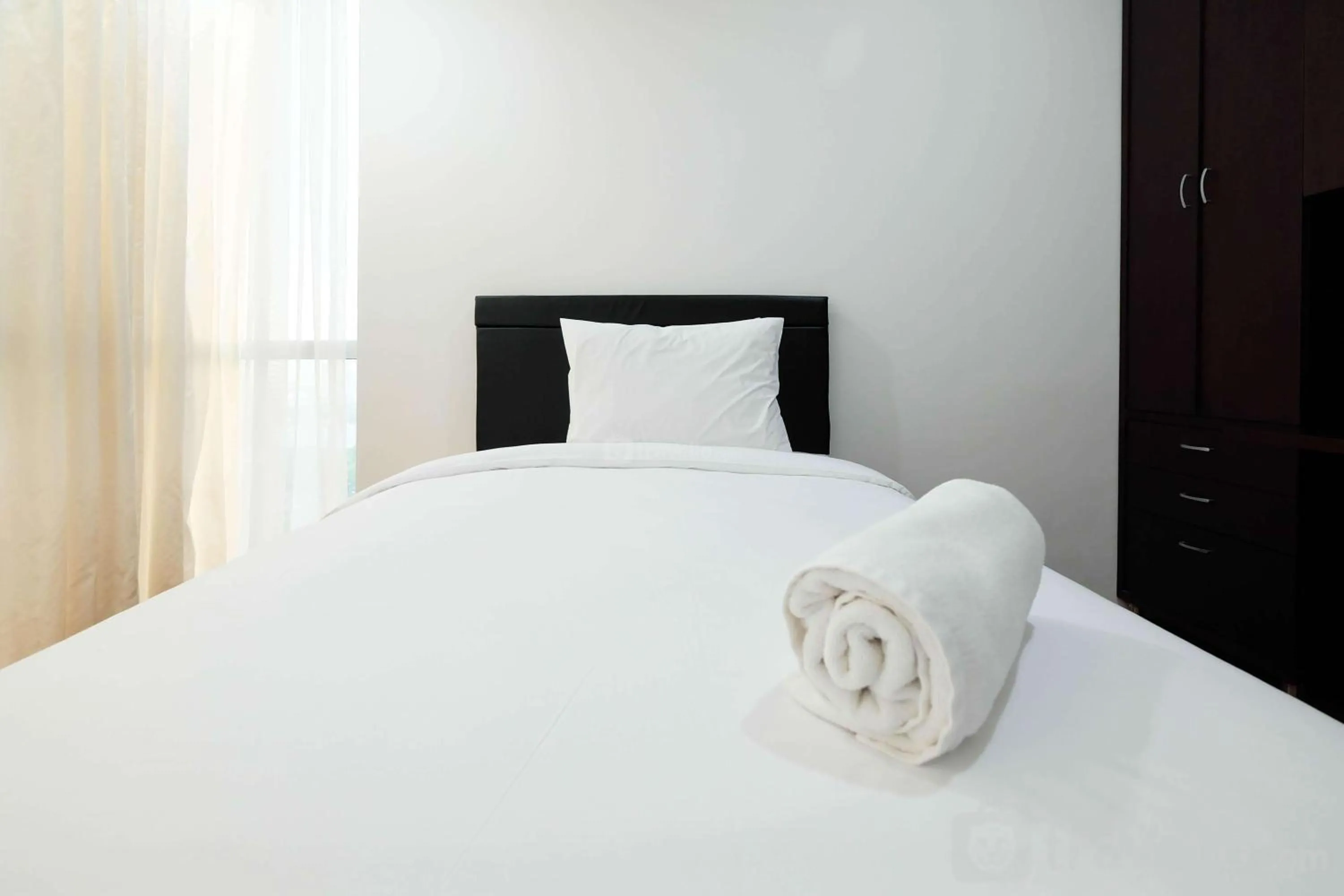 Bed in Luxurious Furnished 2BR Kemang Village Apartment By Travelio