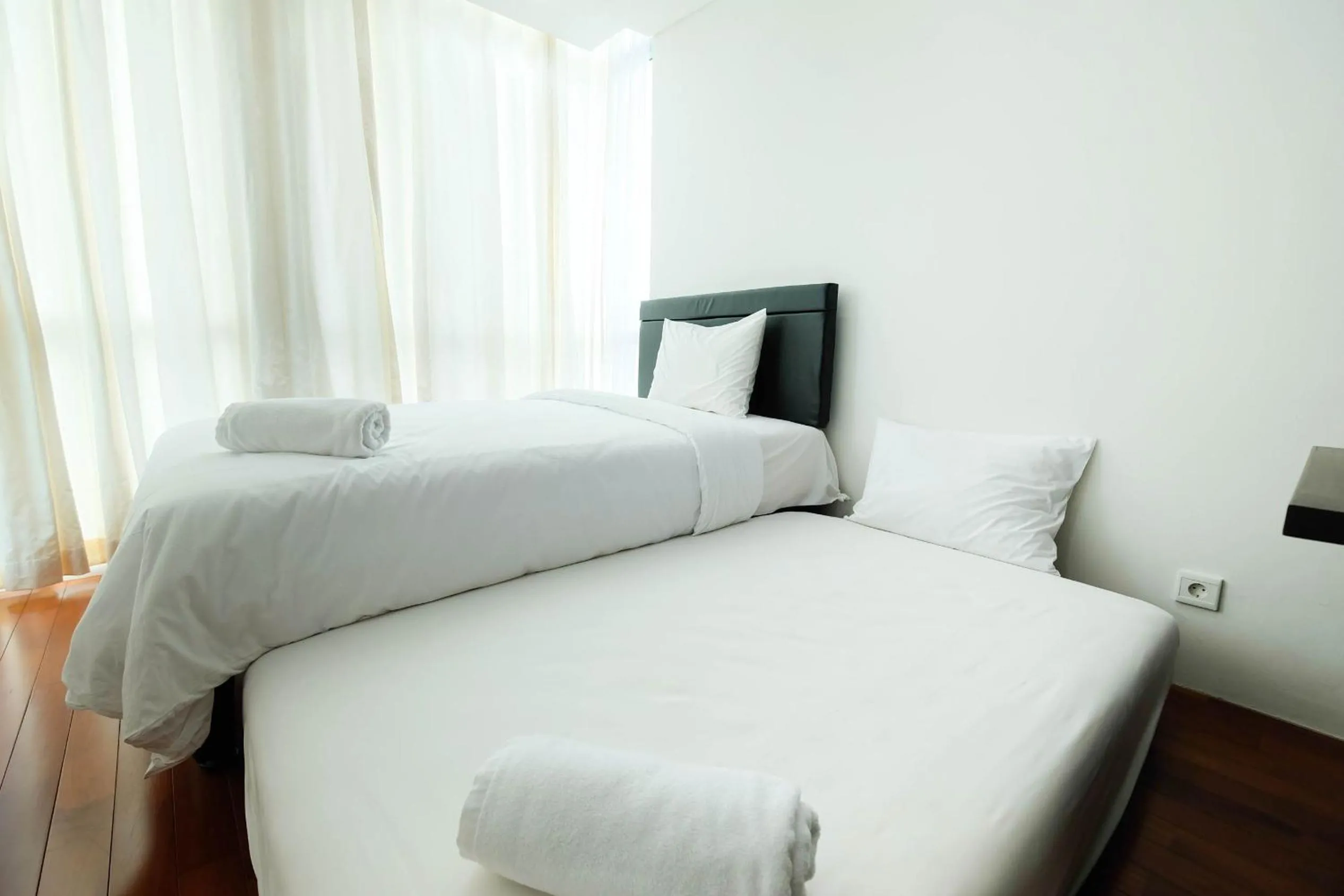 Bed in Luxurious Furnished 2BR Kemang Village Apartment By Travelio