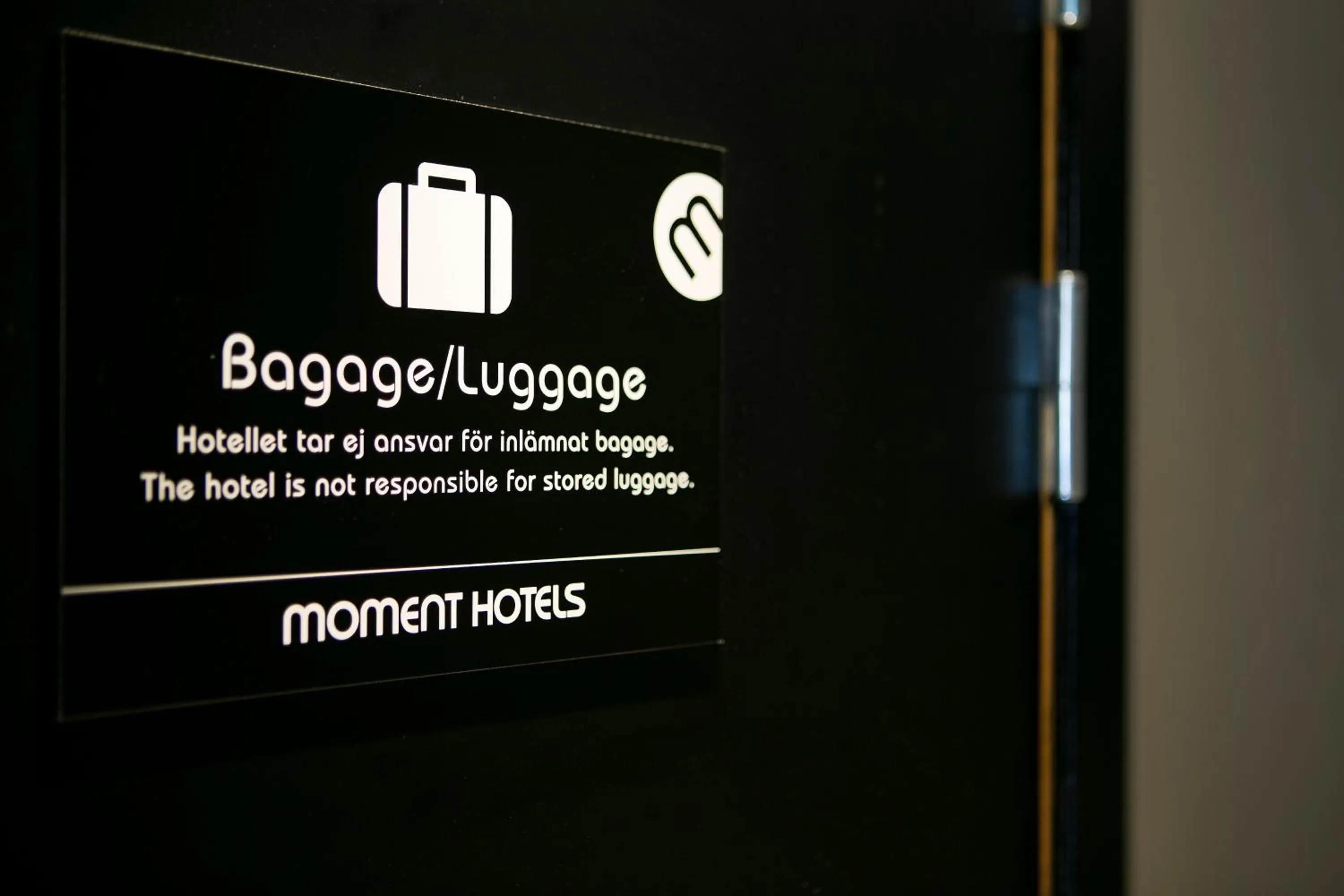 Property logo or sign in Moment Hotels