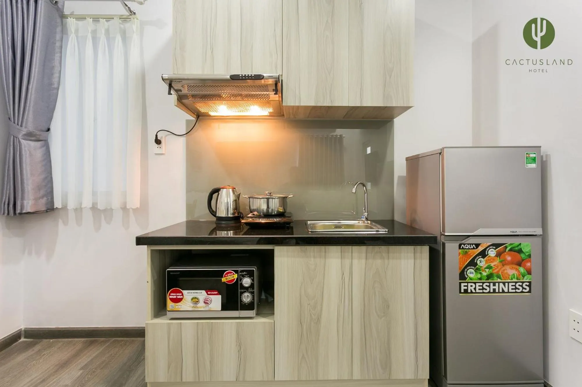 Kitchen or kitchenette in Cactusland Hotel & Apartment
