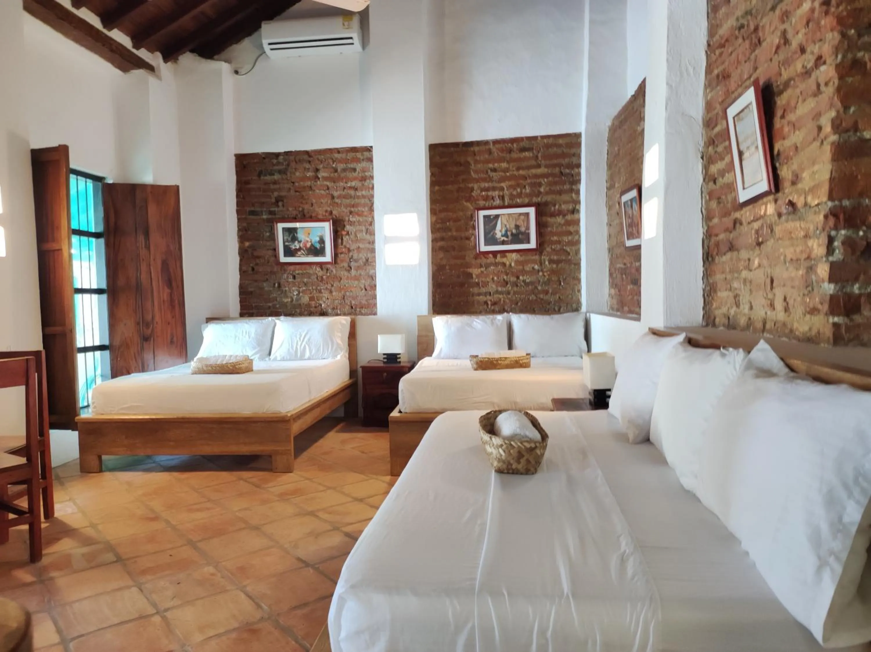 Bed in HOTEL NIETO MOMPOX, ubicado en el corazón del centro histórico, frente al rio magdalena en zona de malecón
