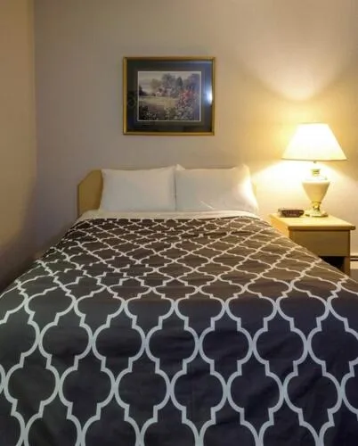 Bed in Perfect Inns & Suites
