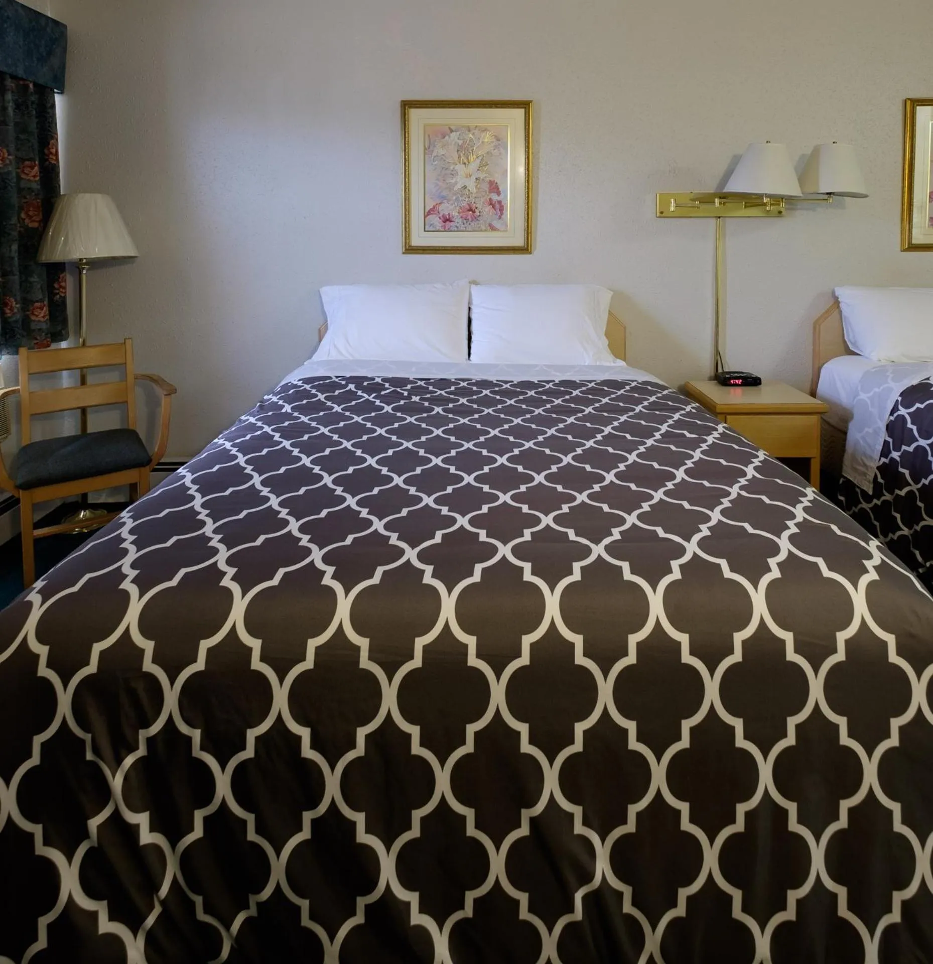 Bed in Perfect Inns & Suites