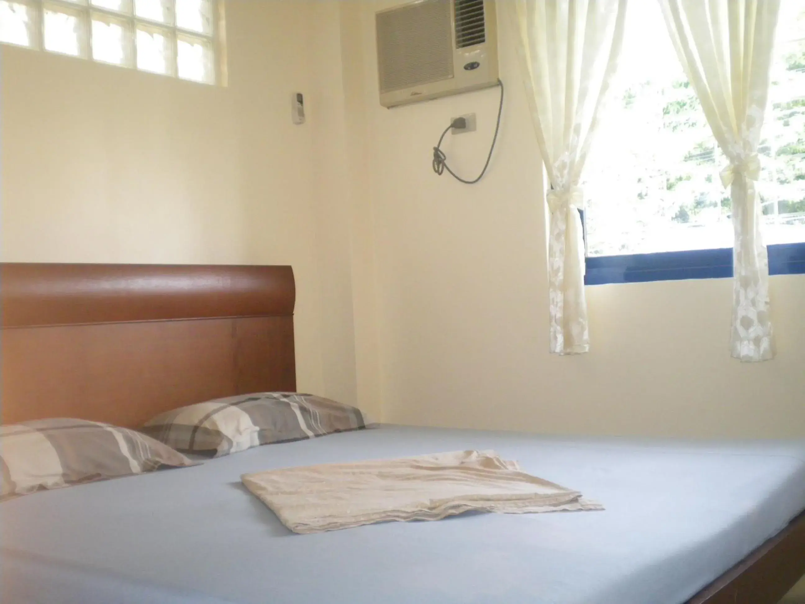 Bed in Dumaguete Springs Apartment