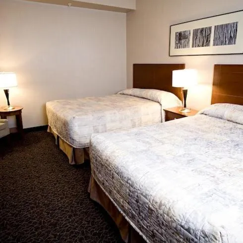 Bed in Heritage Inn & Suites - Brooks