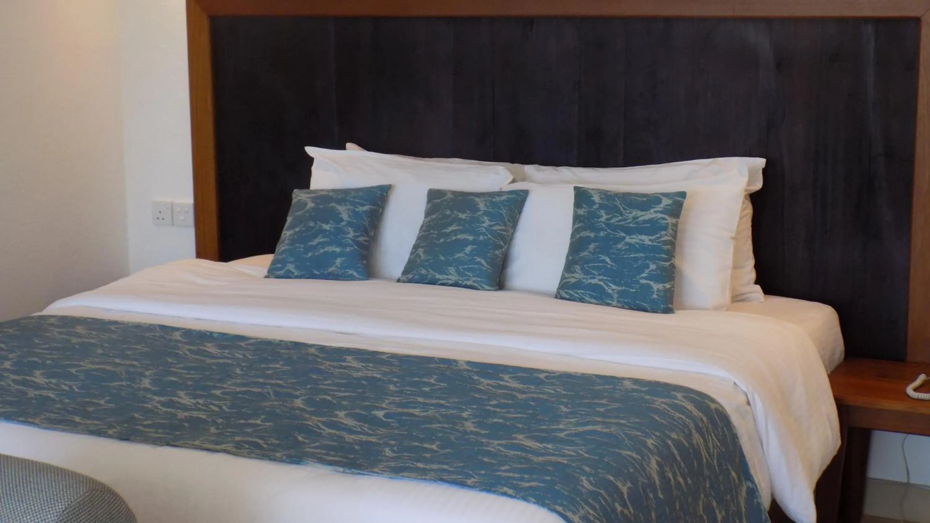 Bed in Travellers Beach Hotel & SPA