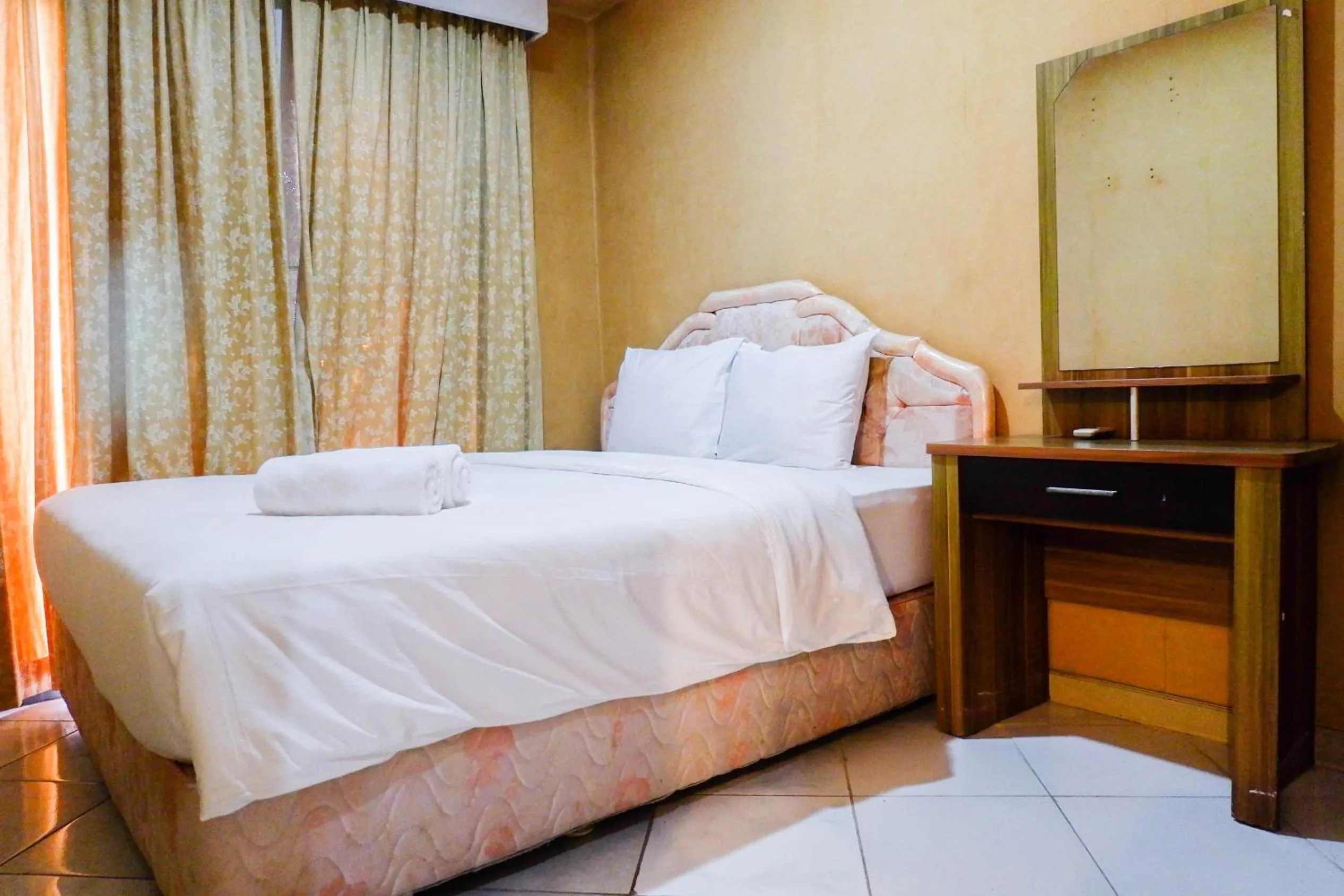 Bed in Spacious 1BR Apartment at Taman Beverly By Travelio