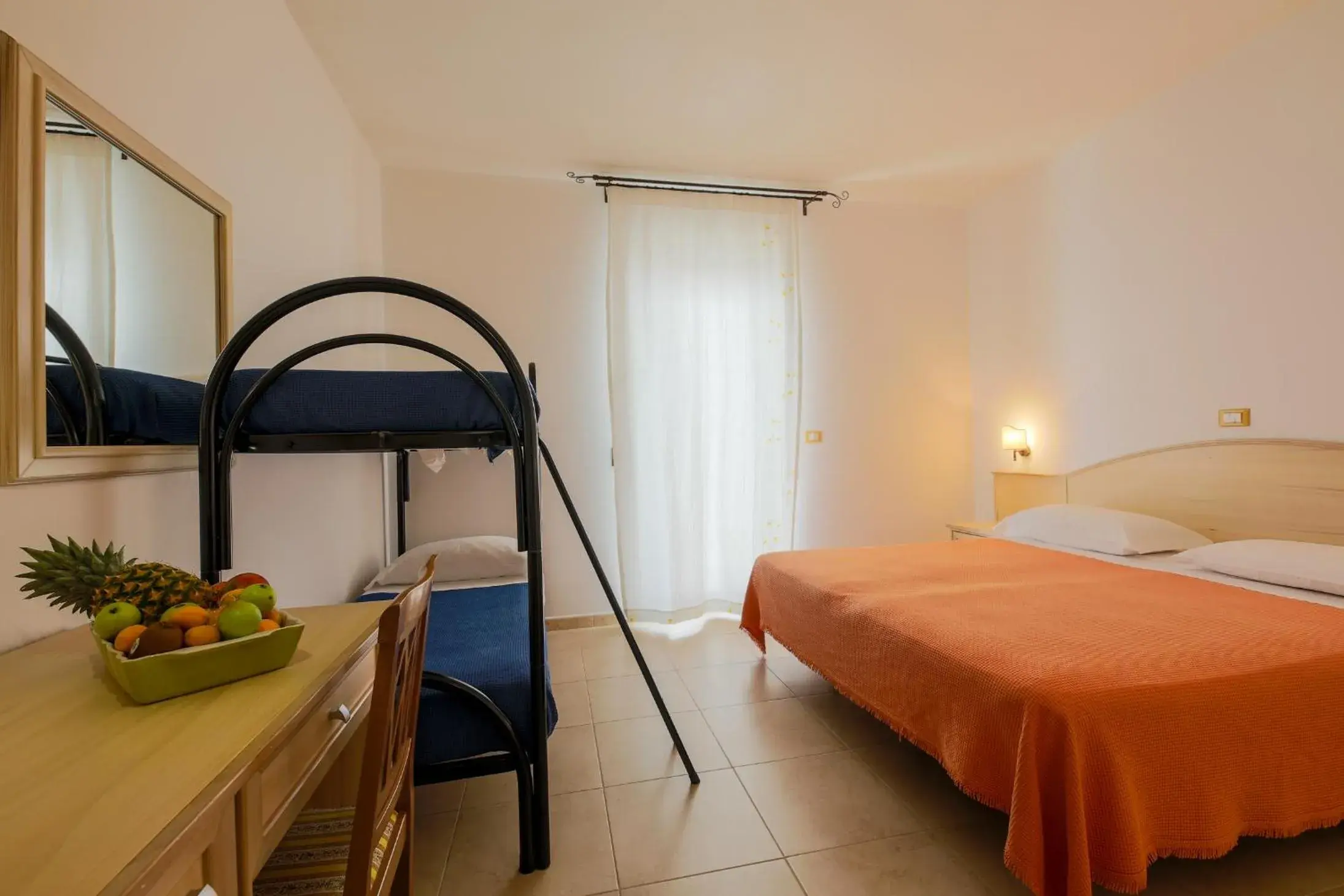 Standard Quadruple Room-basement with patio in Hotel Corallo Standard Quadruple Room-basement with patio in Hotel Corallo