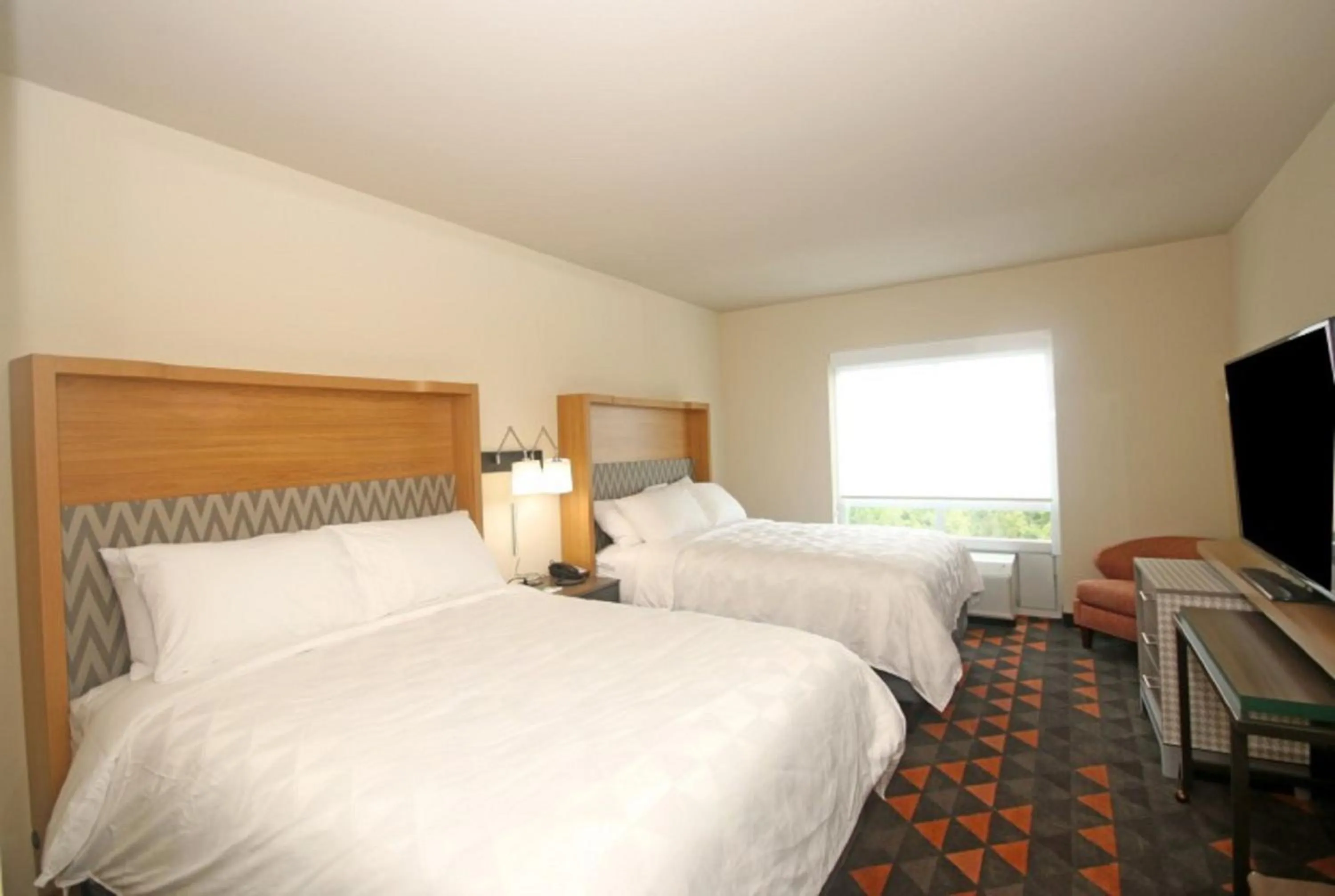Photo of the whole room, Bed in Holiday Inn & Suites - Fayetteville W-Fort Bragg Area by IHG