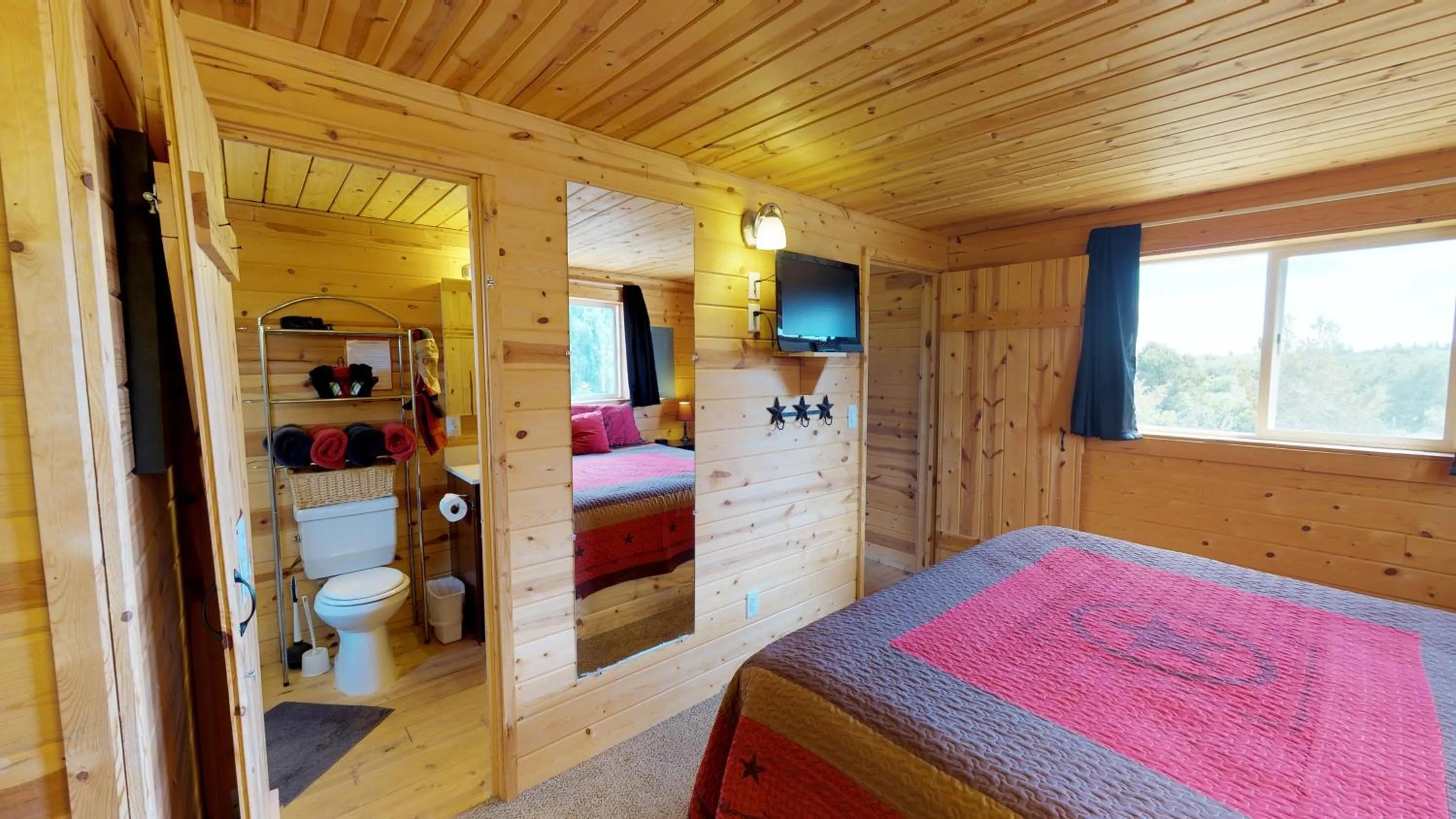 Toilet, Bed in White Pine Cabin by Canyonlands Lodging