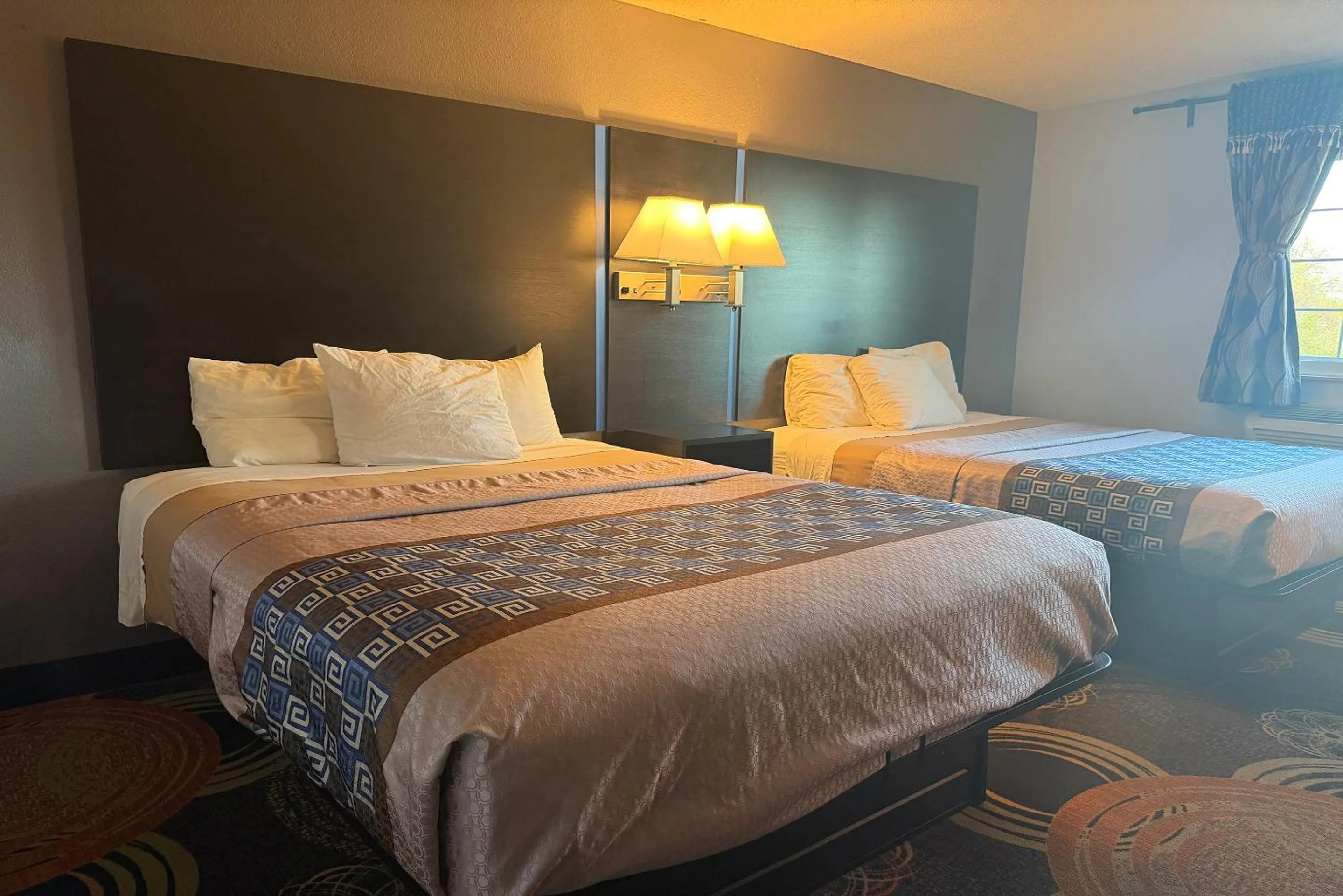 Bed in Coratel Inn and Suites by Jasper Stillwater