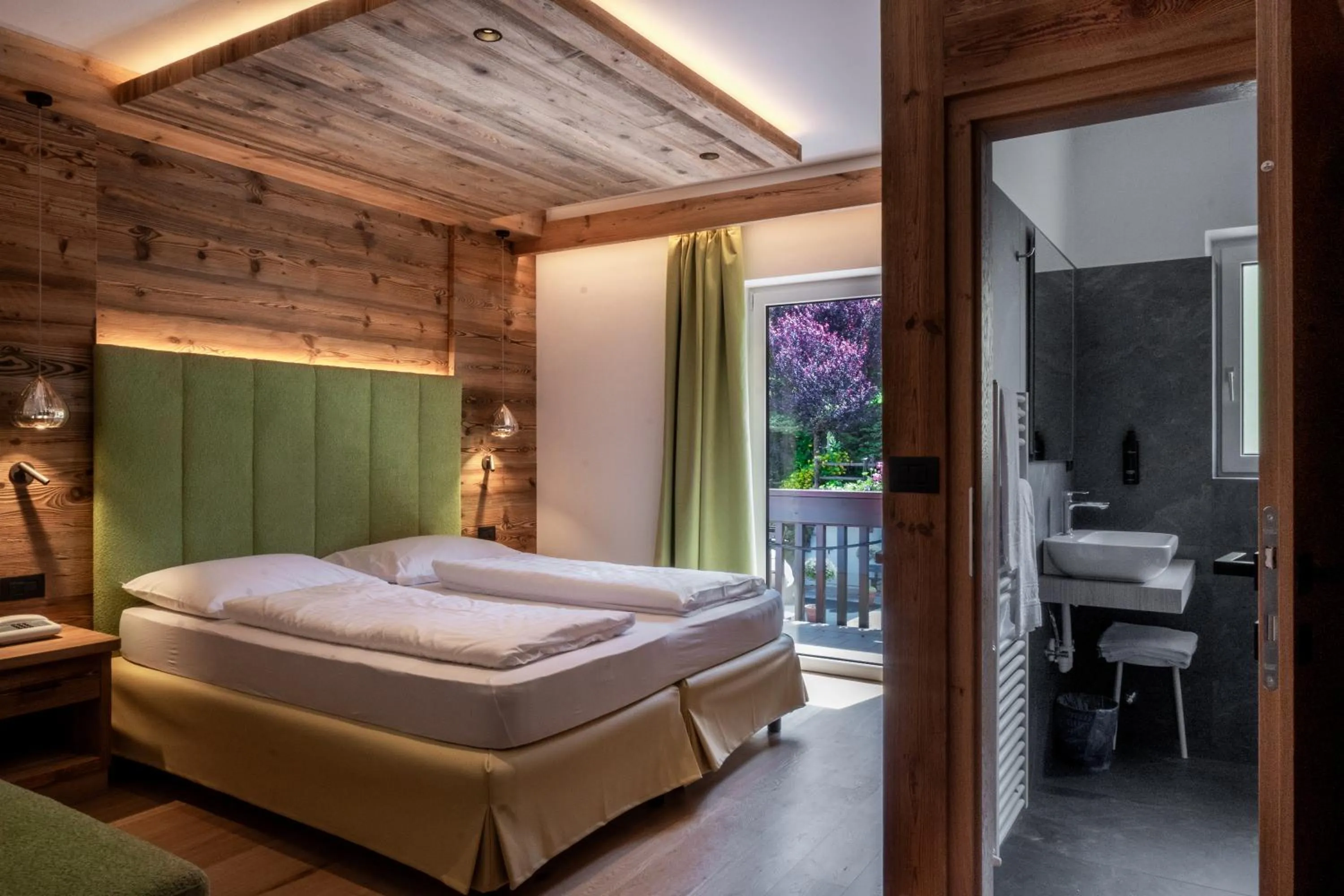 Bed in Belvedere Dolomites Flower Hotel